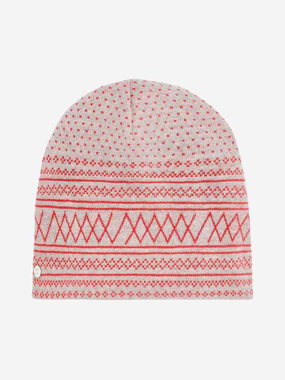 The Setesdal Hat Cream by We Norwegians is a knitted beanie made from luxurious Italian yarn, featuring a geometric pattern in red, pink, and white with triangles and small dots for added texture. The plain white background enhances the intricate details, reminiscent of a classic Setesdal hat.