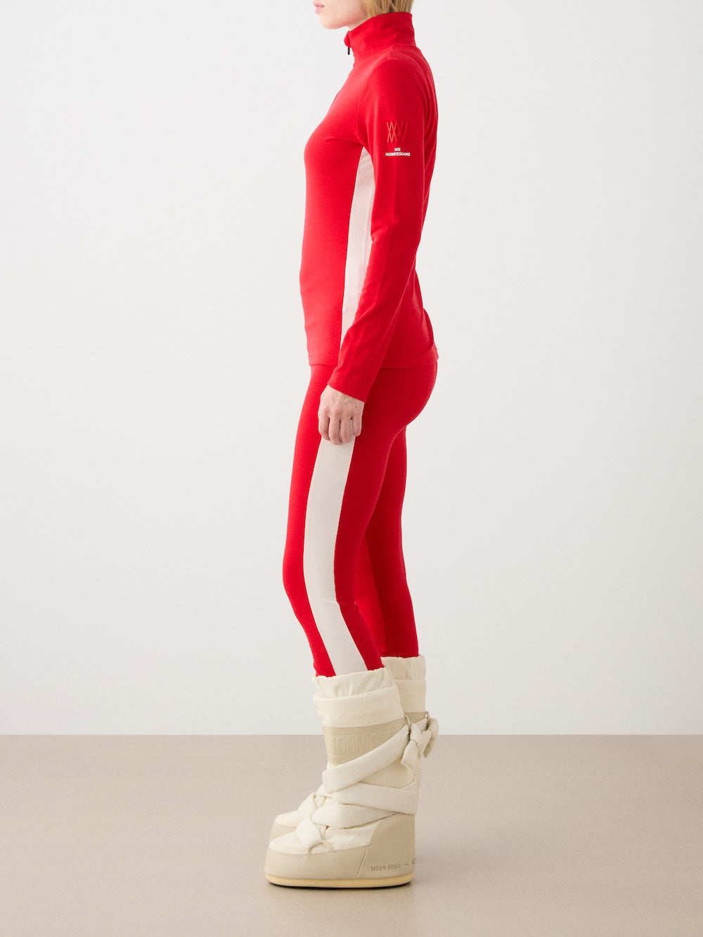 We Norwegians | FW25 | Womens Voss Leggings_Red | Model wearing this fine knitted pair of leggings with contrasting panels on the sides on an off-white background | A perfect base layer or work-out wear | Side