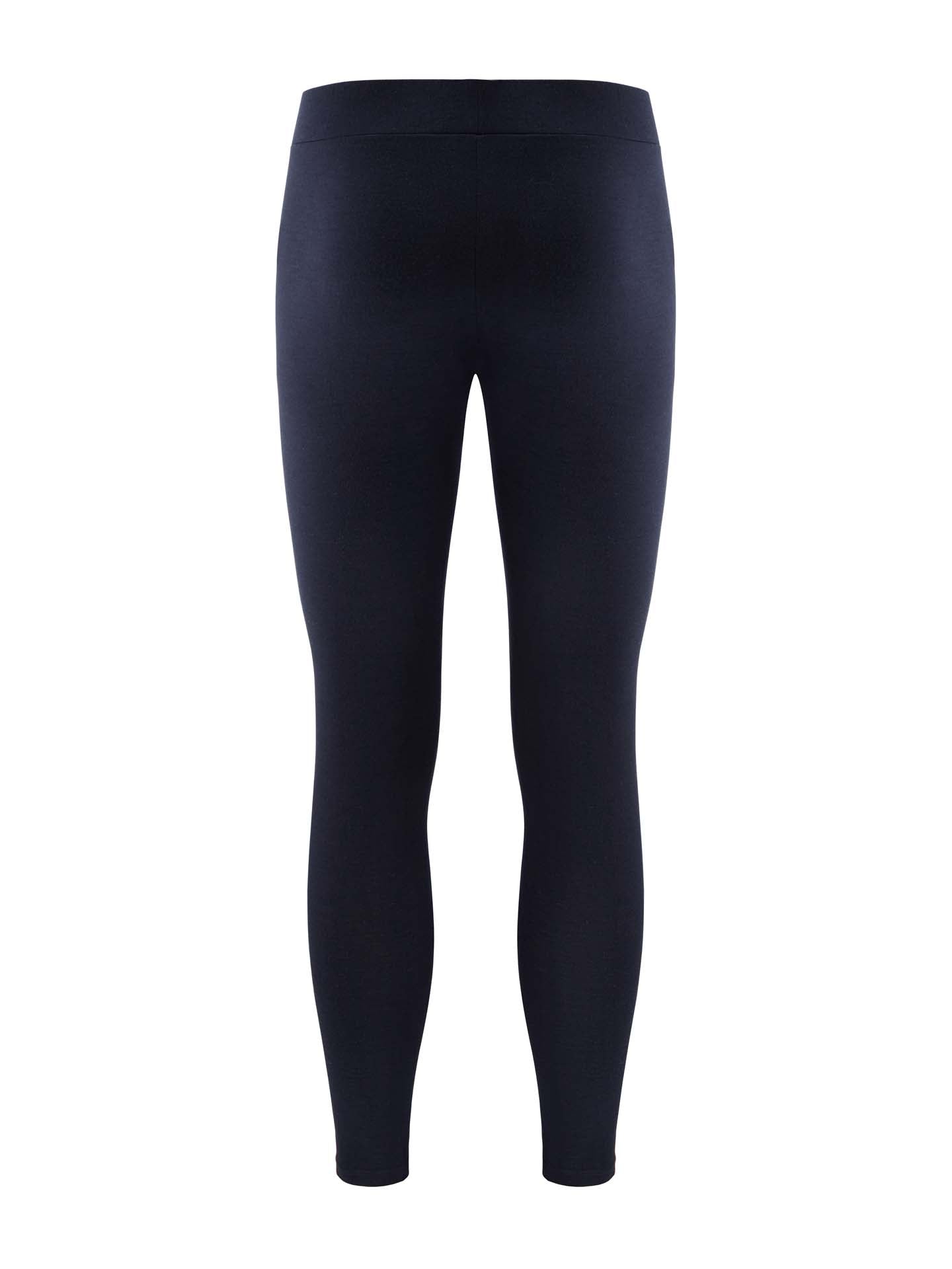 The Sno Merino Long Johns Bottoms Men by We Norwegians, viewed from the back, are a pair of plain black leggings that reach the ankles and offer a snug fit with an elastic waistband. The fabric looks smooth, stretchy, and breathable, making them suitable for casual wear or workouts.