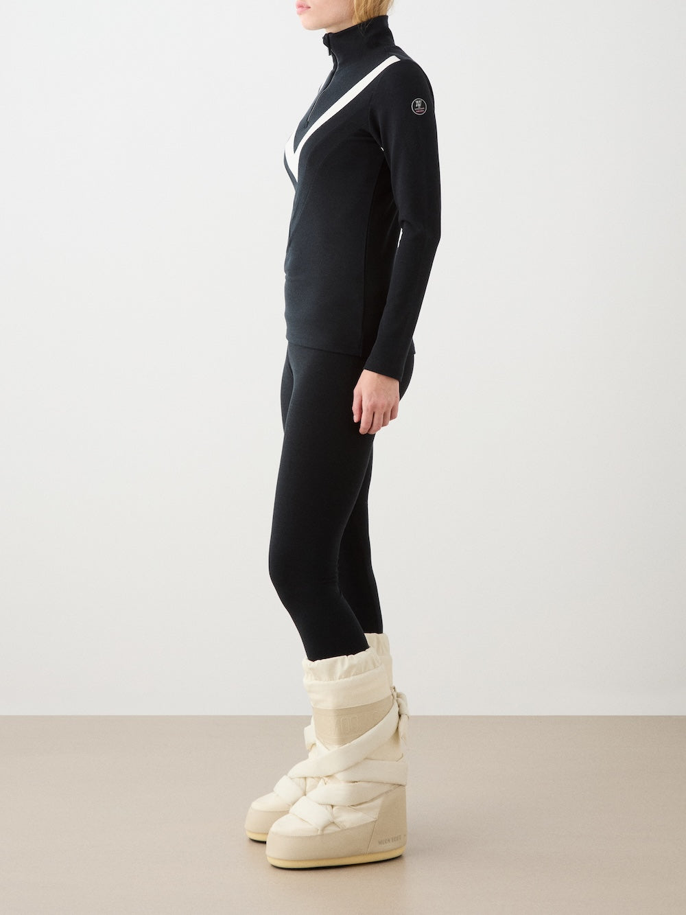 We Norwegians | FW25 | Womens Ski Basic legging_Black | Model is wearing these fine pair of knitted leggings that make a perfect base layer | Image shot against an off-white background | Side