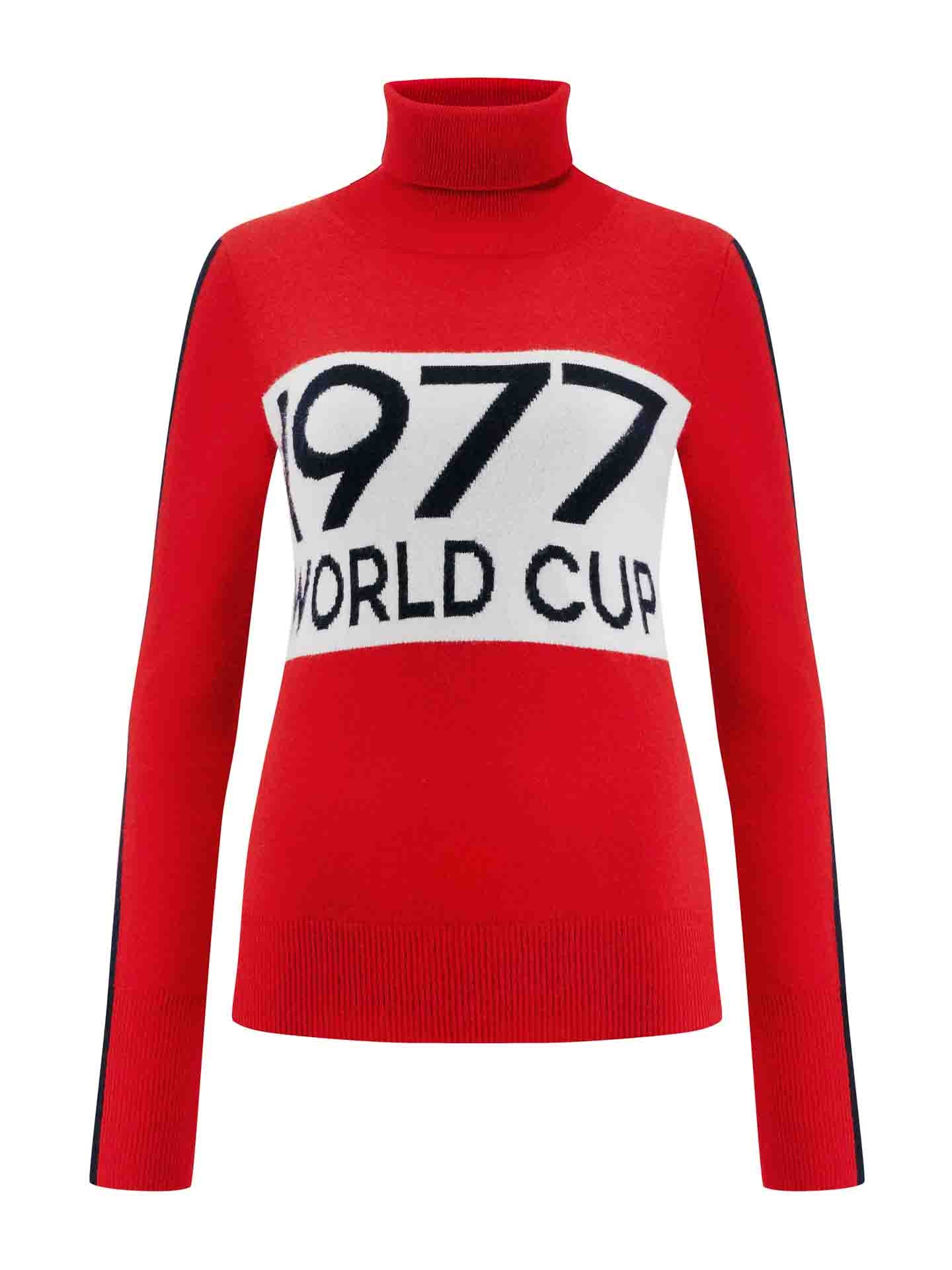 The 1977 World Cup Sweater Women Red by We Norwegians is a red turtleneck sweater with long sleeves. The front features a white rectangular section adorned with the text "1977 WORLD CUP" in bold, black letters. Perfect for ski fashion enthusiasts, this retro-themed 1977 sweater offers both warmth and style reminiscent of classic World Cup competitions.