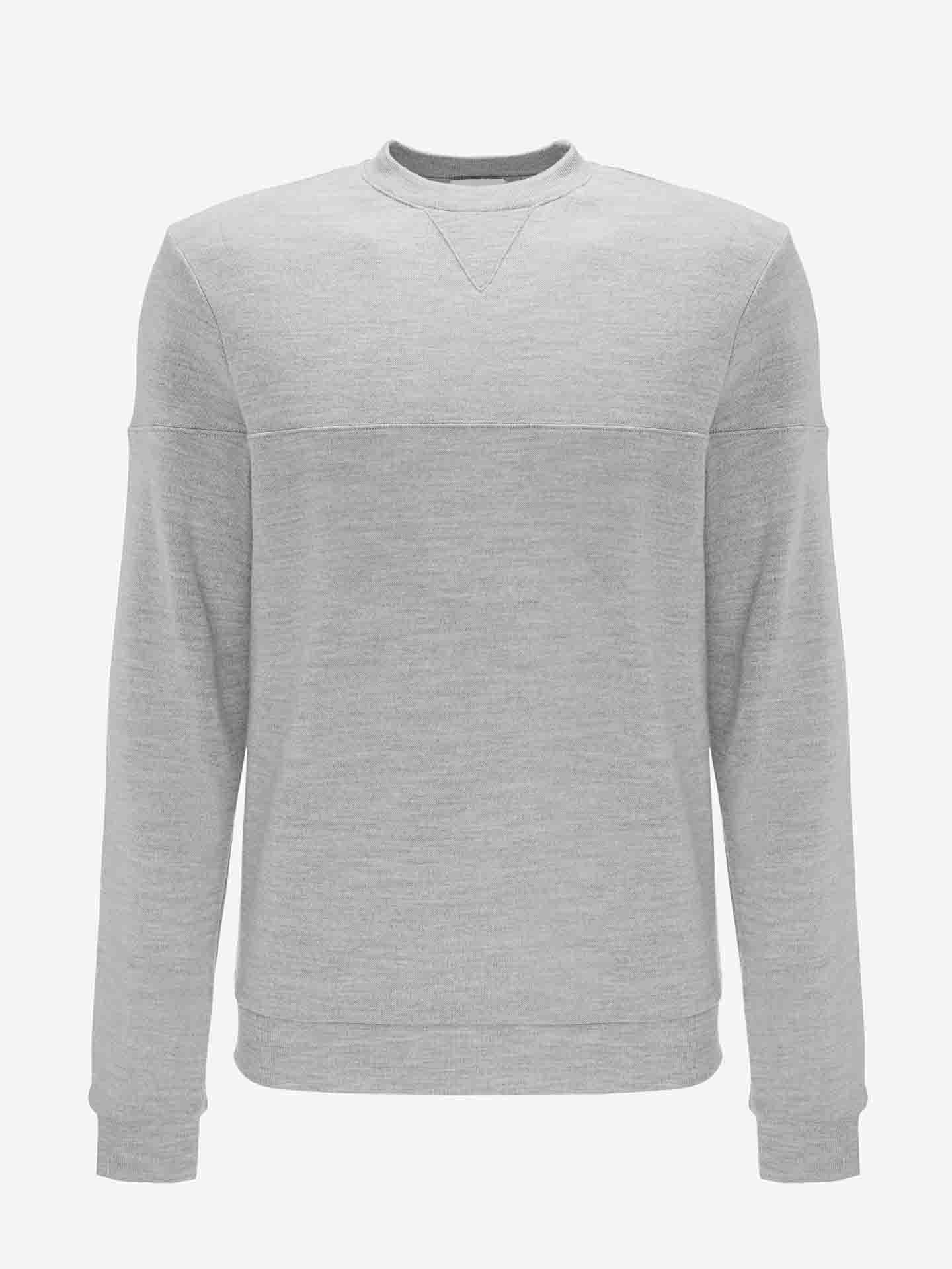 The Tind Crewneck Men by We Norwegians is a plain grey crew neck sweatshirt crafted from soft Merino wool. It features long sleeves, ribbed cuffs and hem, and a unique triangular stitching detail at the front neckline. Ideal for pairing with Tind Joggers, this sportswear piece is showcased against a white background.