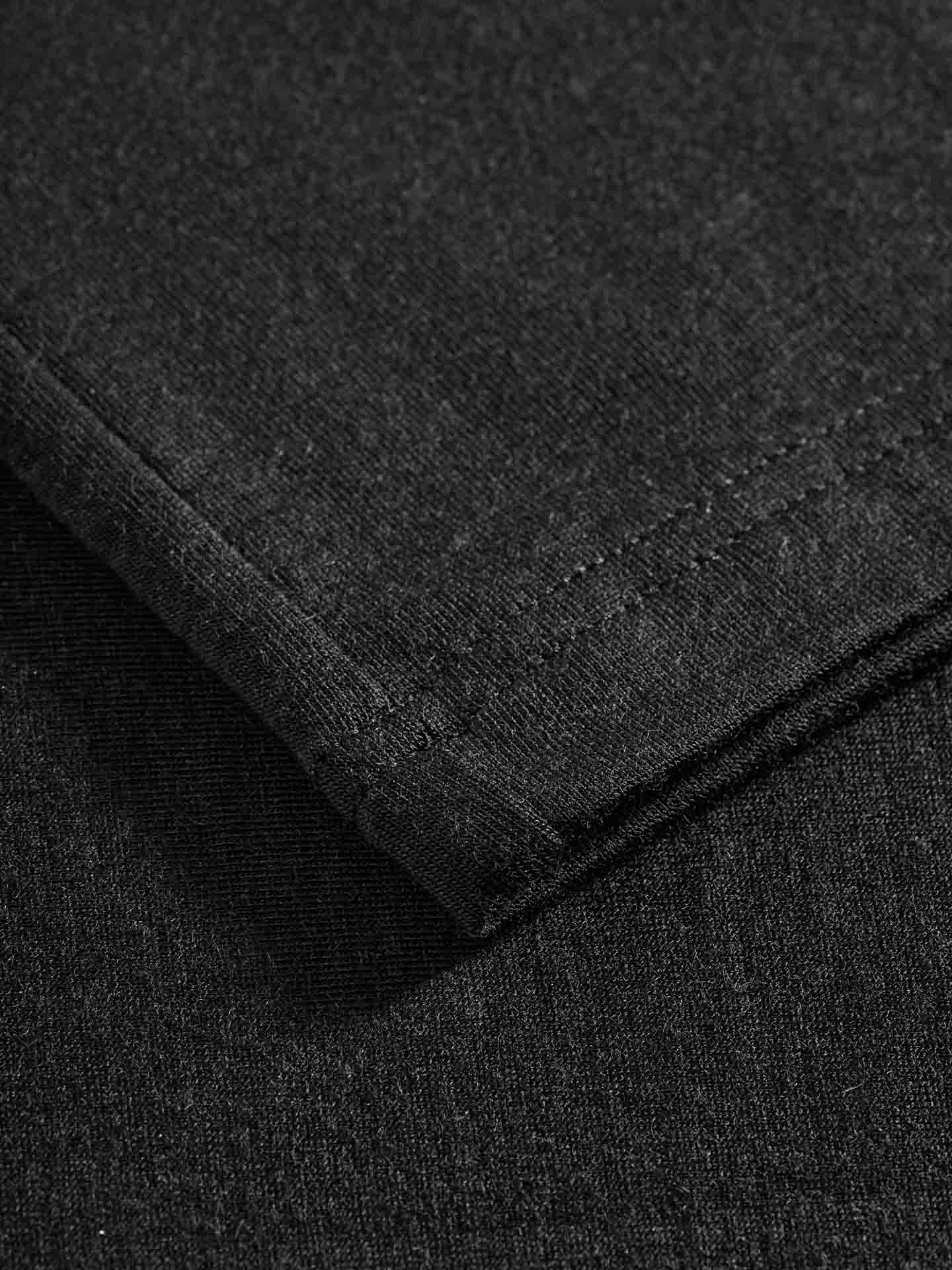 Close-up view of the Hygge Turtleneck Women's hem by We Norwegians, showcasing a neat double-stitching detail. The fabric, likely Tencel, appears to be soft and slightly textured.
