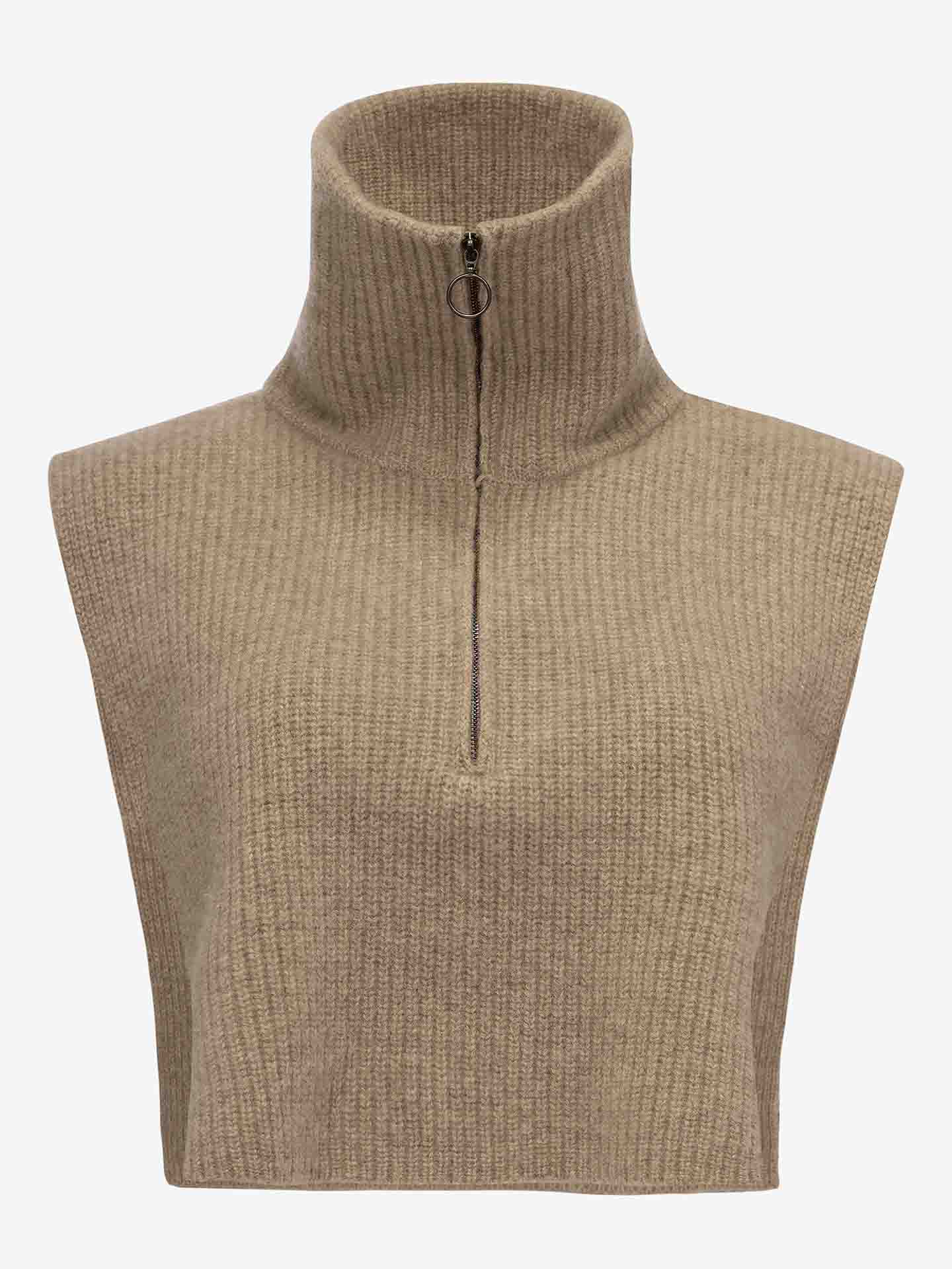The Blefjell Cashmere Bib for Women by We Norwegians is a sleeveless, beige ribbed knit piece made from luxurious cashmere. It features a high, folded collar with a metal half-zip closure, making it ideal for layering. Its textured fabric provides a cozy and warm appearance.