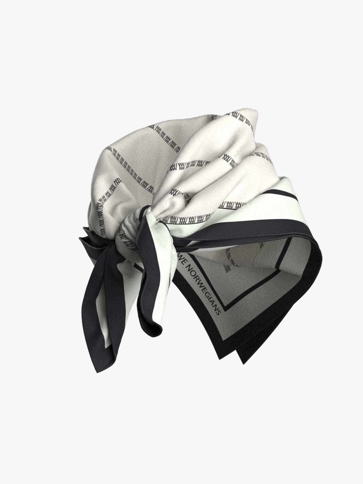 A close-up image of a folded *We Norwegians* Ship Silk Scarf White in monochrome colors including black, white, and grey. The scarf features a series of small, rectangular patterns with a border. It is partially tied, showcasing its exquisite texture and luxurious silk-twill fabric.