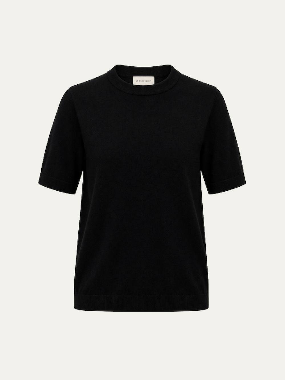 The We Norwegians Club Top Women - Summer Cashmere, a plain black lightweight short-sleeve crew neck sweater, is shown against a light background with a small white label inside the collar.