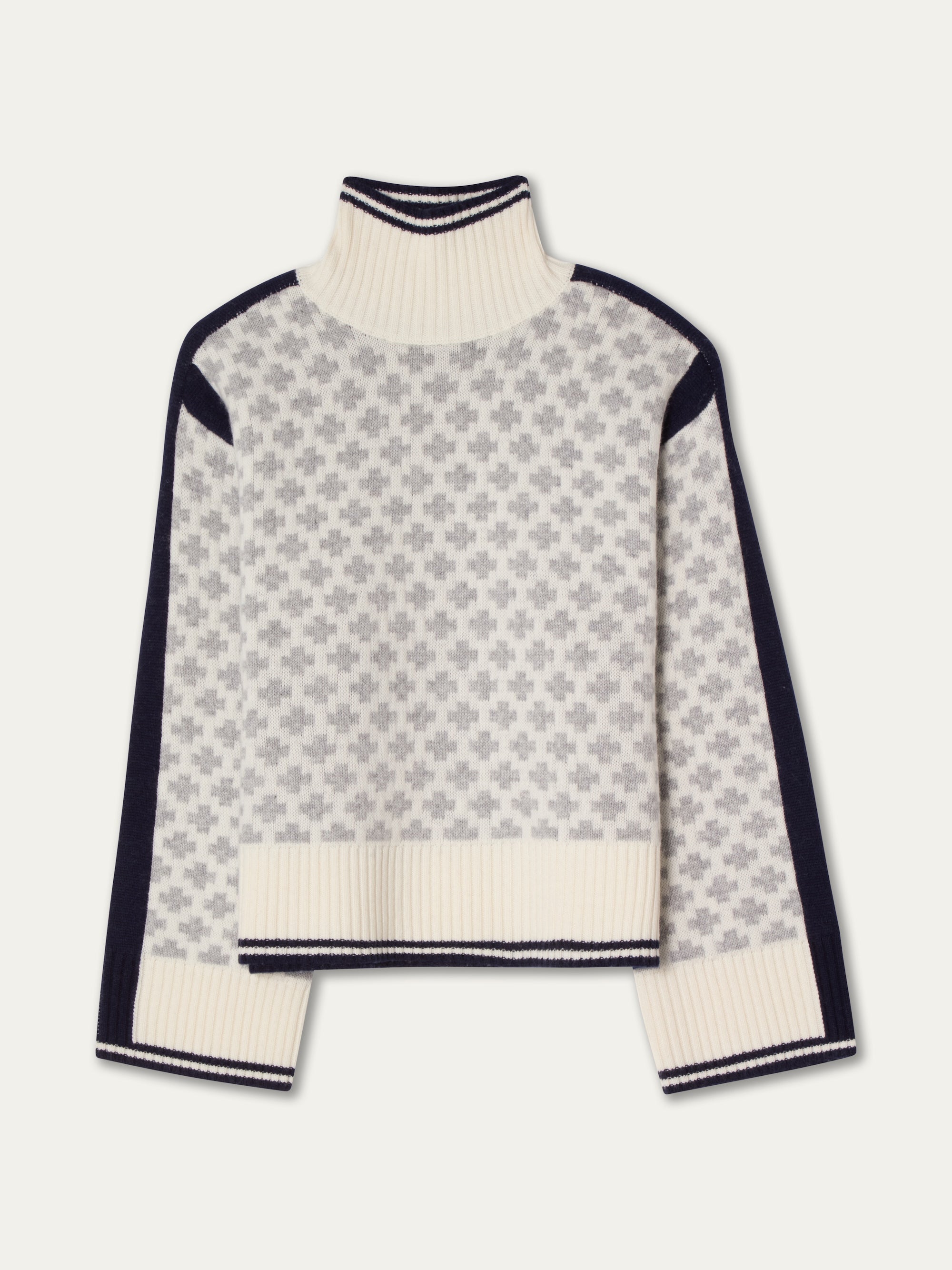 The We Norwegians Boat Sweater Women is a cream and gray merino cashmere turtleneck with long sleeves, geometric cross pattern, navy side panels, and ribbed cuffs, hem, and neckline.