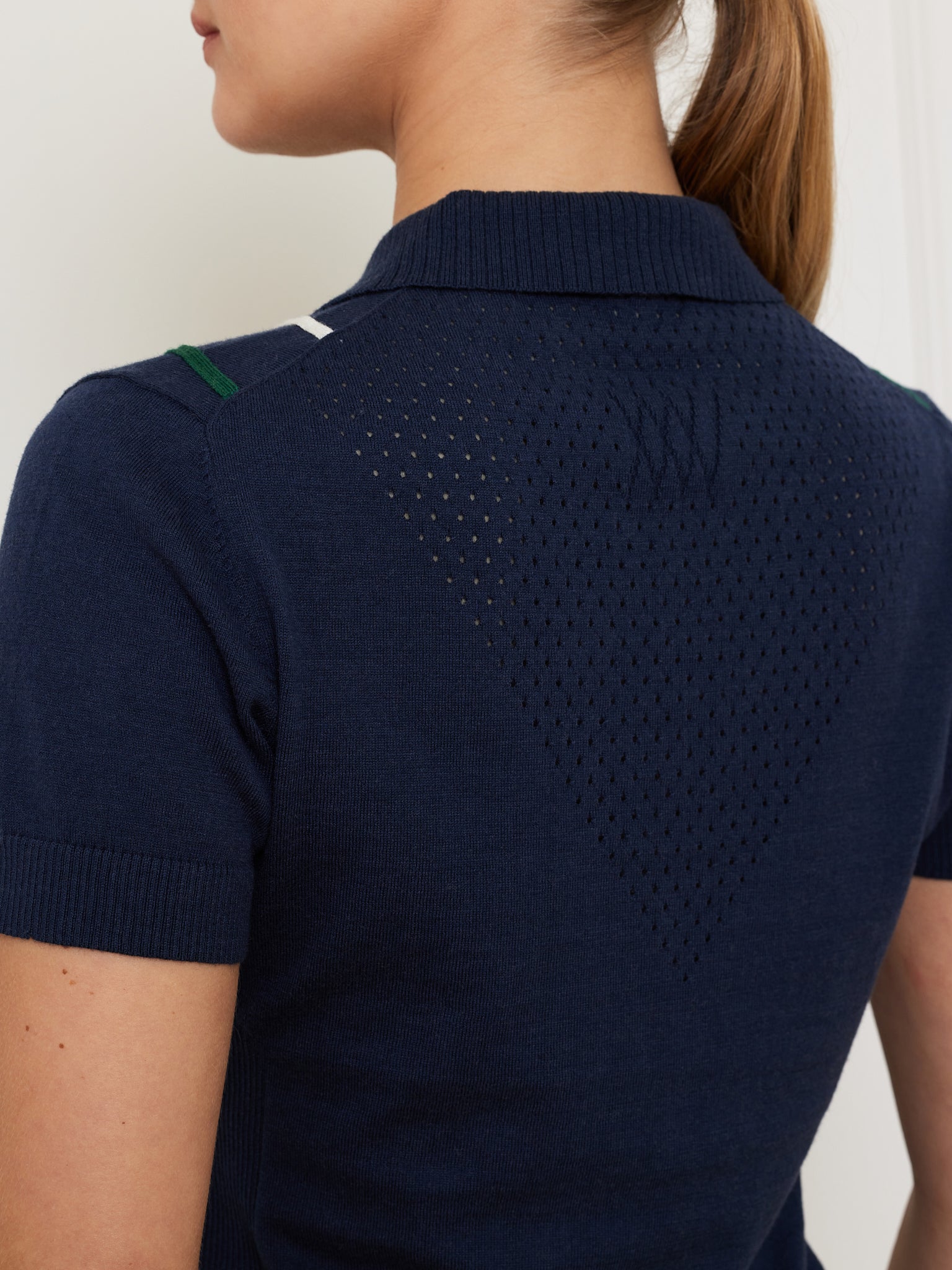 A person wearing a We Norwegians Team Chevron Polo for women.