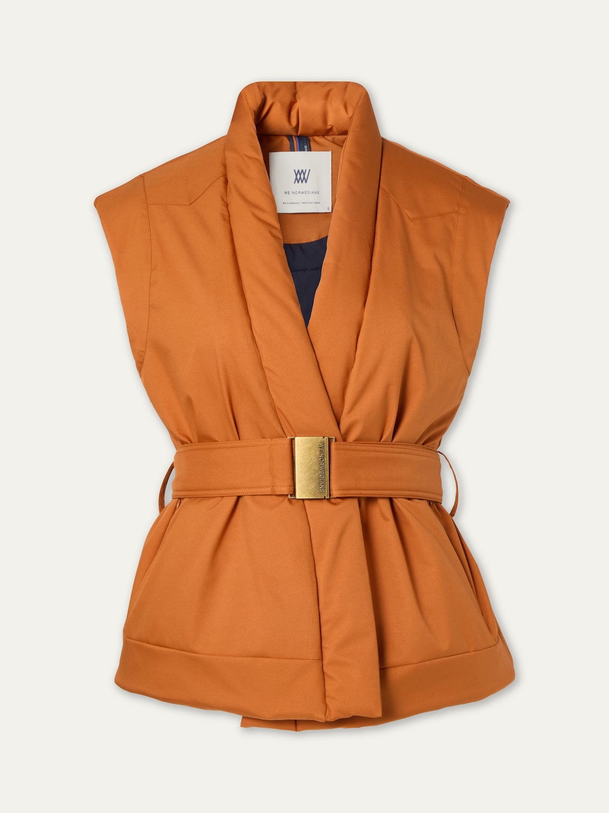 The Western Vest Women by We Norwegians is a sleeveless orange wool padded vest with a wide collar and matching belt with gold buckle, shown on a plain background—a vintage-inspired ski vest ideal for après-ski style.