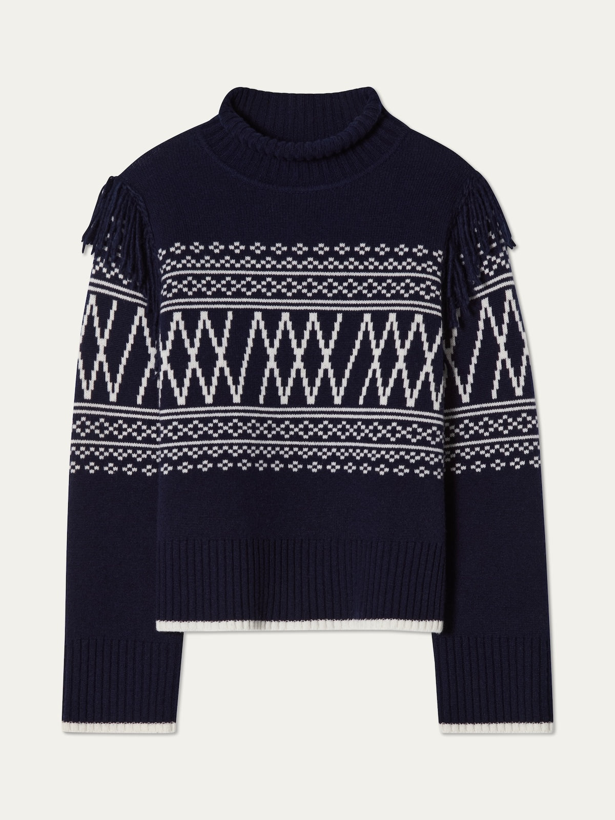The We Norwegians Setesdal Sweater women features navy blue knit inspired by Norwegian patterns, with white geometric designs, long sleeves, ribbed cuffs and hem, plus fringe detailing on the shoulders.