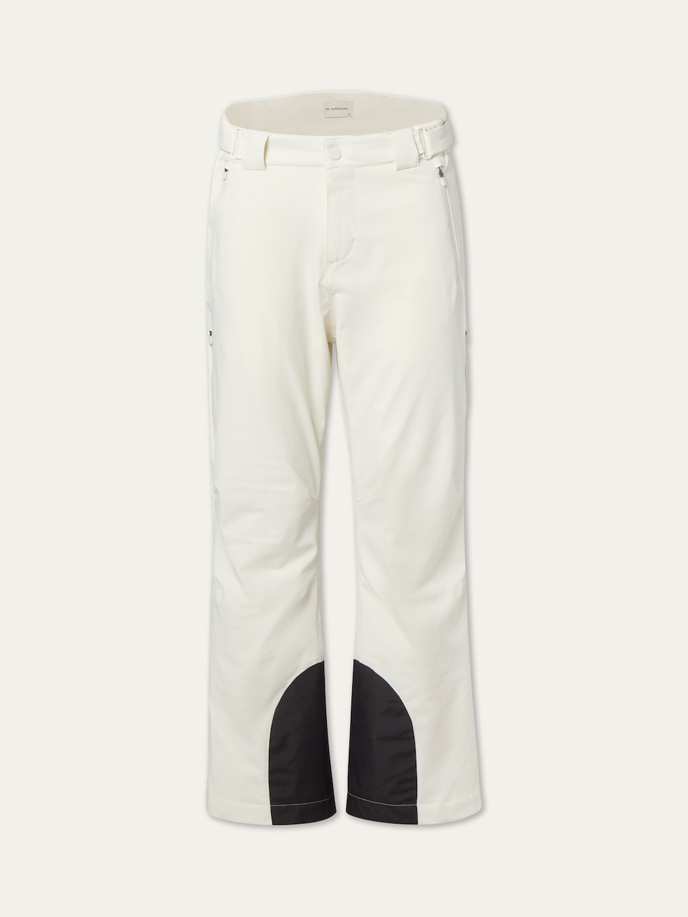 The We Norwegians Hammerfest Ski Pant men is a white, wool-insulated ski pant with front pockets, belt loops, and black reinforced inner leg patches. Waterproof and stylish, these pants are shown against a plain white background.