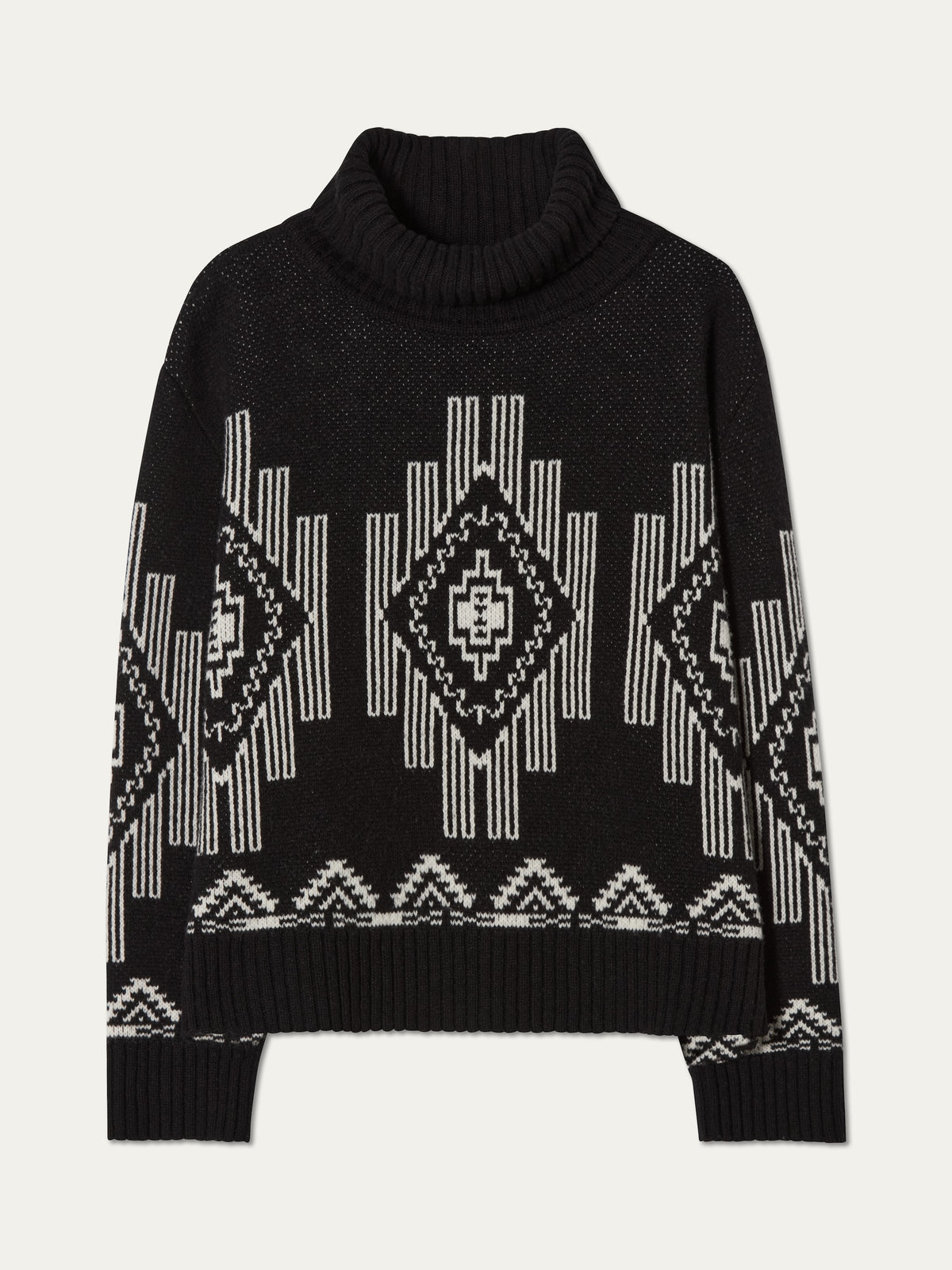 The We Norwegians Pioneer Sweater for women is a black, long-sleeve wool blend inspired by après-ski style, showcasing white geometric diamond and zigzag patterns on the chest, sleeves, and hem.