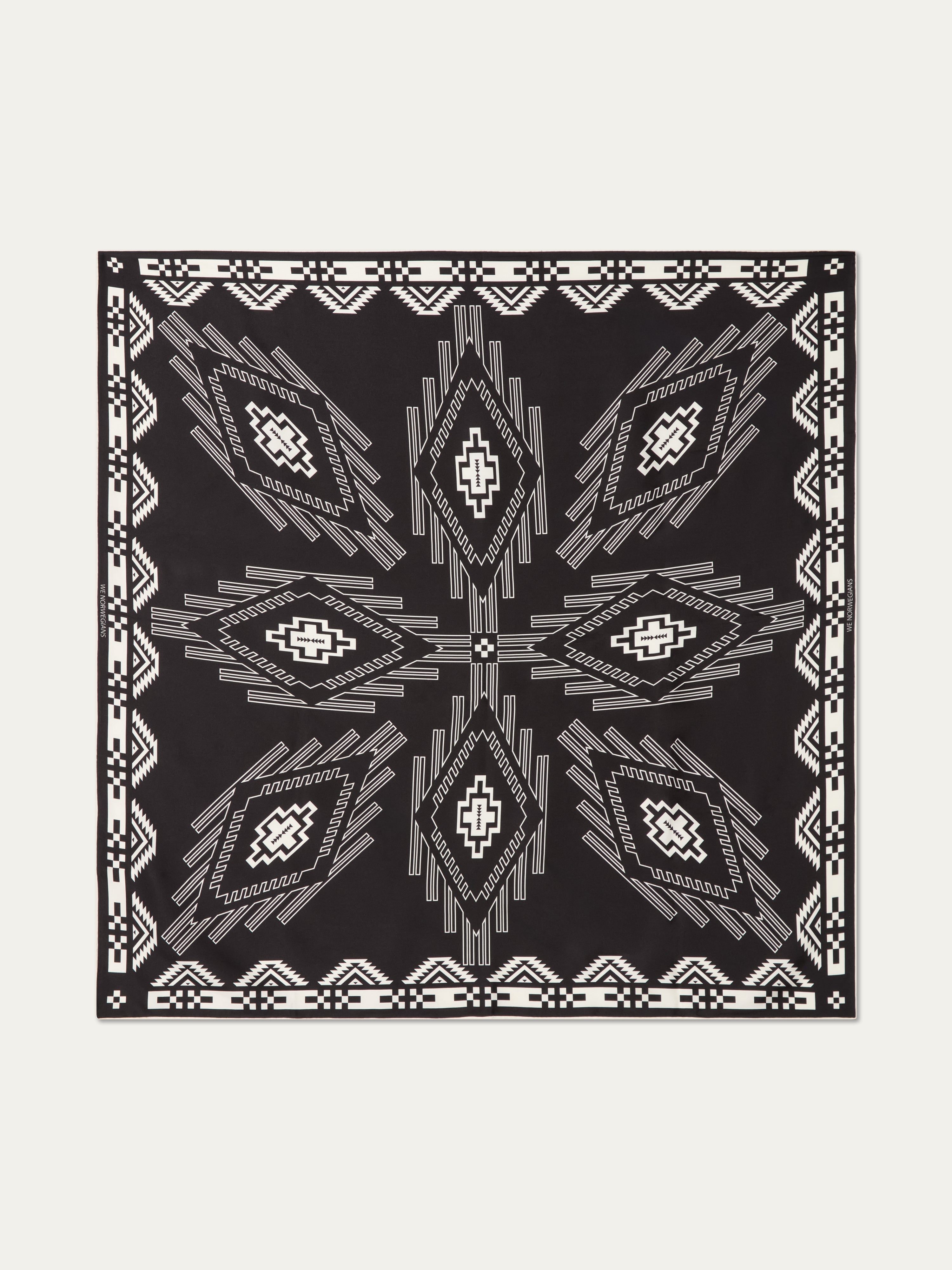 We Norwegians | FW25 | Pioneer Silk scarf_Black | A pure silk scarf printed with motifs inspired by Indigenous Native American art against an off-white background