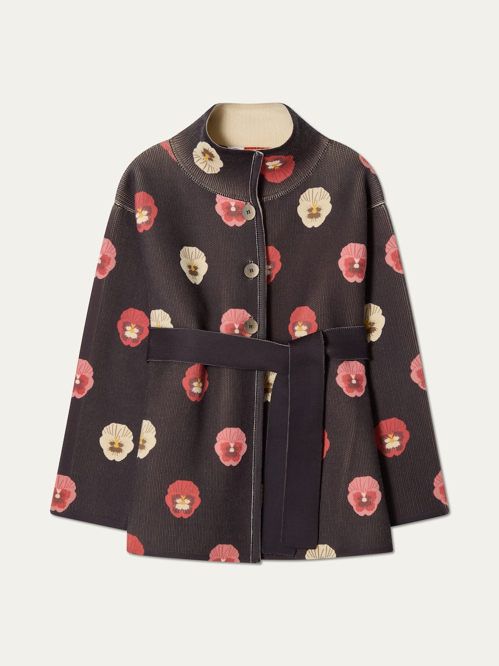 The WN x Markarian Jacket women by We Norwegians is a dark, limited edition, long-sleeve wool jacket with a belted waist and bold red, pink, and white floral prints, shown on a plain background.