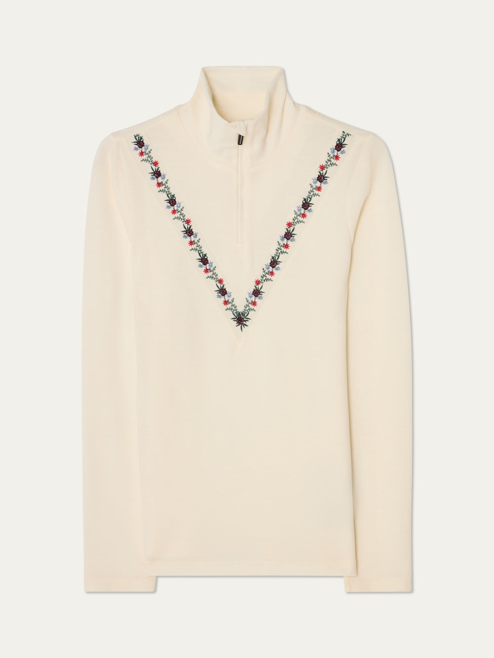 The WN x Markarian ZipUp women by We Norwegians is a cream merino wool long-sleeve top with a quarter-zip collar and red, black, and green V-shaped floral embroidery. Part of the limited-edition collection with Markarian.