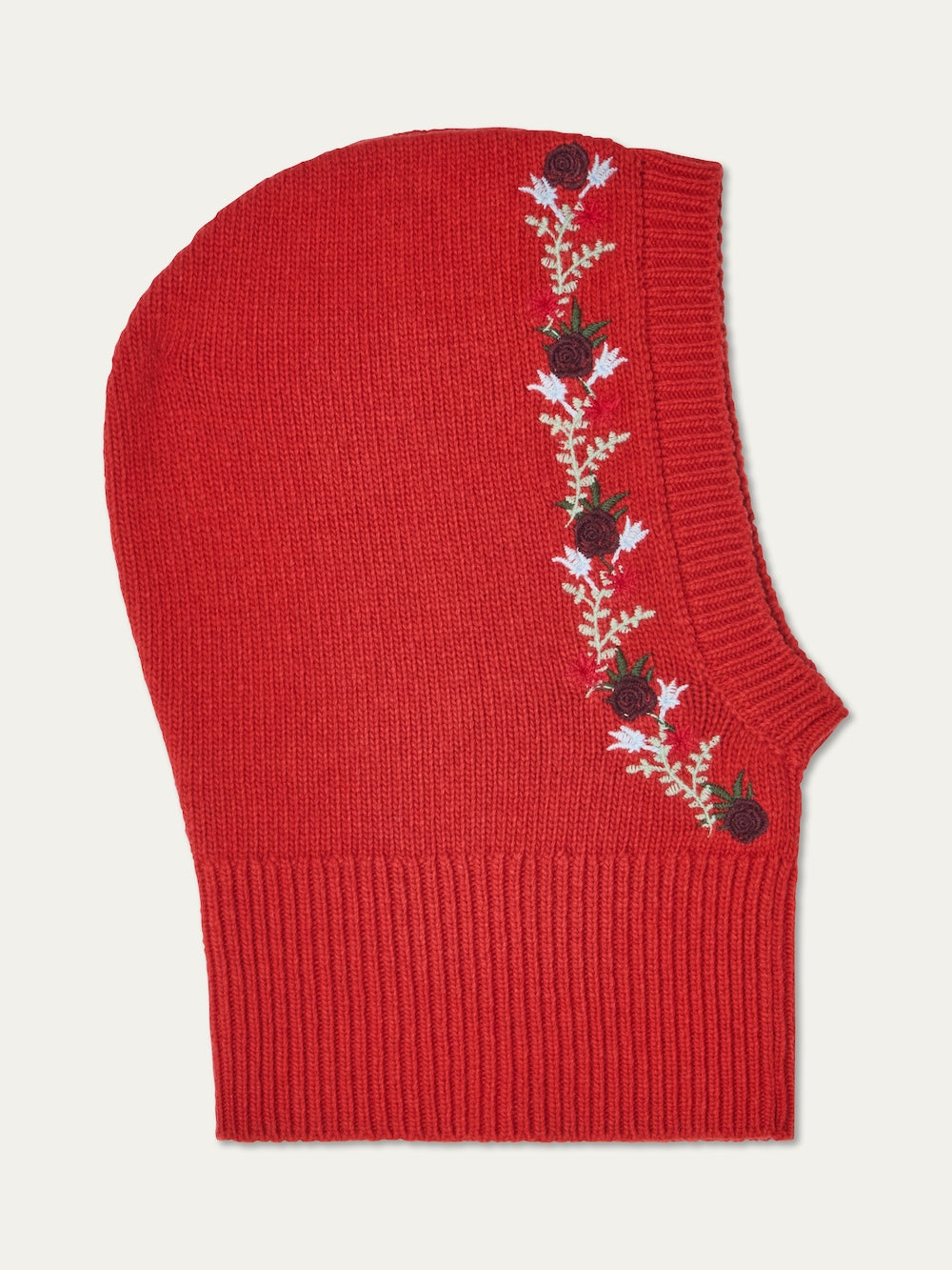The WN x Markarian Balaclava women by We Norwegians is a limited edition red knit wool piece with ribbed edging and floral embroidery in black and red, plus white and green leaves along one side.