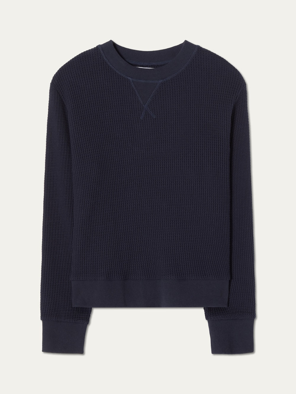 The We Norwegians Waffle Crewneck Women is a navy blue, long-sleeve sweatshirt with ribbed cuffs, hem, and collar in a relaxed fit, shown flat on a white background.