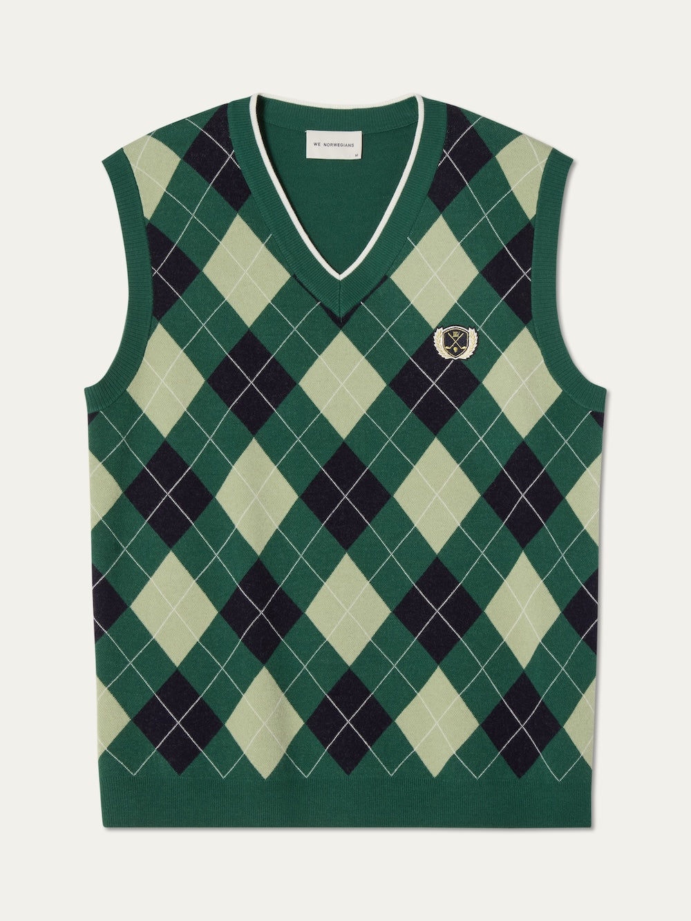 The We Norwegians Fairway Vest Men is a sleeveless V-neck argyle knit sweater vest in dark green, light green, and black with an embroidered crest patch—ideal as a stylish golf vest.