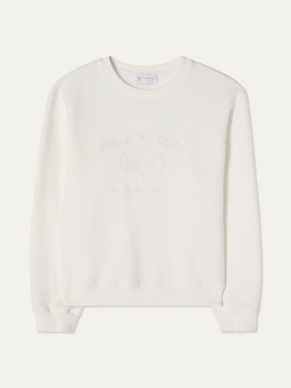 The We Norwegians Bounce Sweater Men is a plain white velour crewneck with subtle embossed chest details, including crossed tennis rackets and laurel branches, for a vintage tennis-inspired look.