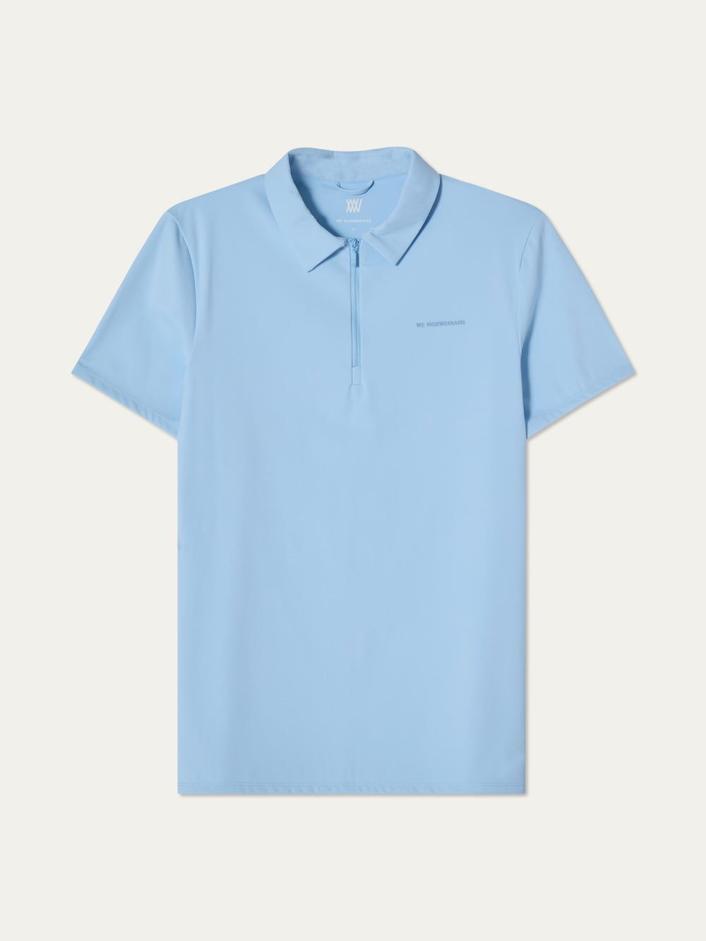 The We Norwegians Honor Zipped Polo Men is a light blue, short-sleeve performance polo with a collar and front zip. Subtle chest text. Made from high-performance fabric, perfect for active days or as a golf polo. Displayed flat on a plain background.
