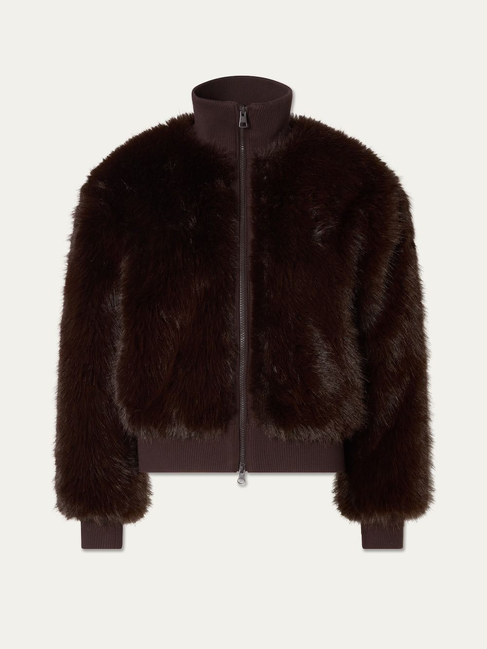 The Dovre Jacket Women by We Norwegians is a dark brown faux fur bomber zip-up jacket, featuring ribbed cuffs, hem, and collar, displayed on a white background. Inspired by classic alpine style, this jacket blends warmth and sophistication to create a timeless winter look.