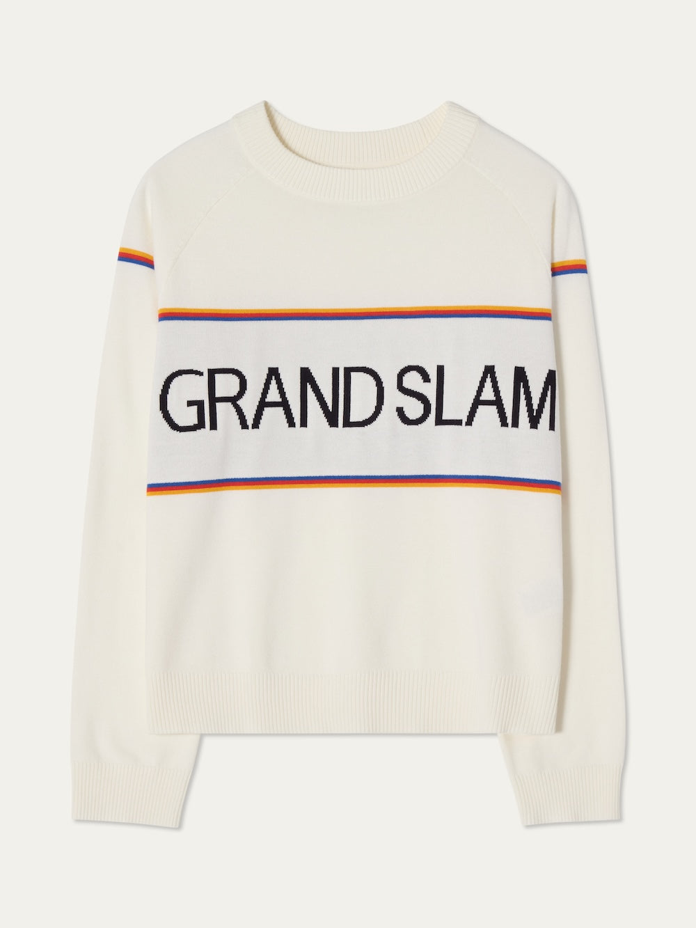 The Grand Slam Sweater Women by We Norwegians is a white knit with “GRAND SLAM” in bold black letters, yellow, orange, and blue stripes, long sleeves, and a crew neck—ideal for a vintage-inspired après sport look.