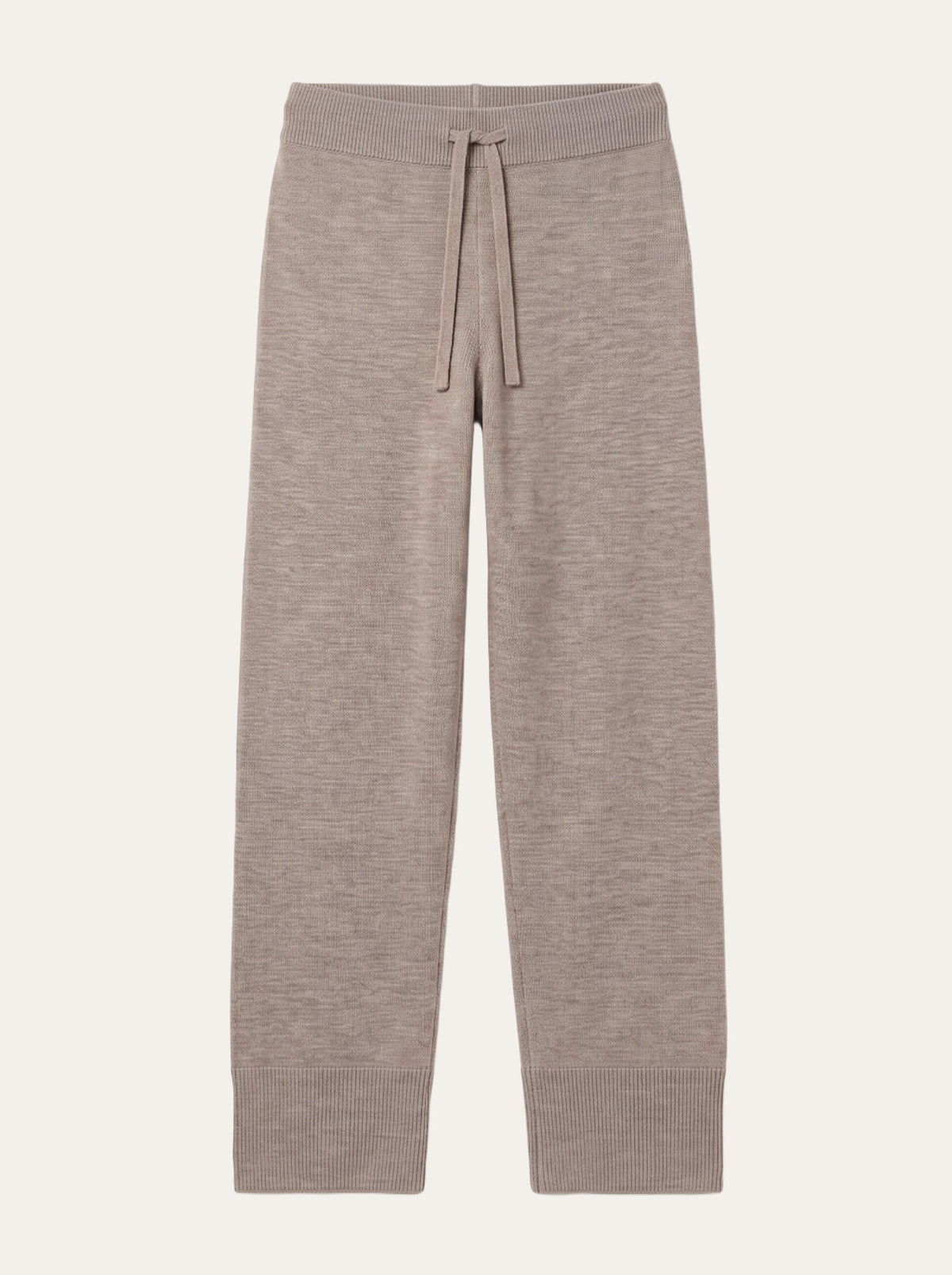 The We Norwegians Geilo Track Pant Women is a pair of beige knit lounge pants crafted from soft merino wool, featuring a drawstring waistband, wide ribbed cuffs, and a relaxed fit—perfect loungewear that is conveniently machine washable. Shown flat on a white background.