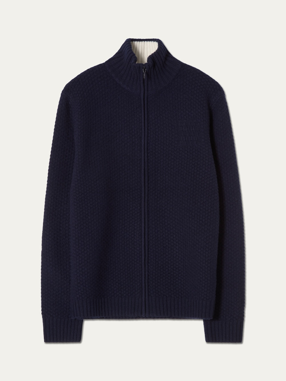 The We Norwegians Kikut FullZip Men is a navy blue, full-zip cardigan featuring a high collar, ribbed cuffs and hem, crafted in a classic alpine sweater style and laid flat on a plain white background.