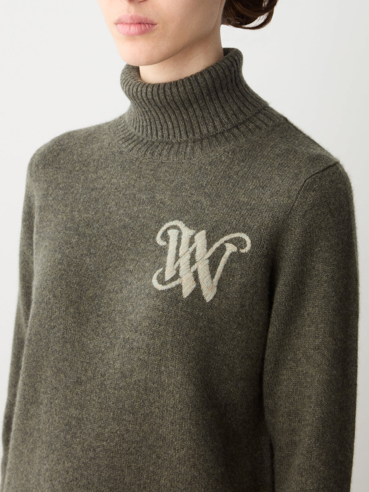 Olive green Monogram Cashmere Sweater Women with a large embroidered monogram logo on the chest.