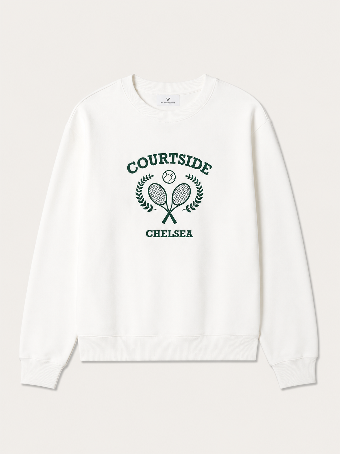 The We Norwegians Chelsea Sweater Women is a white cotton jersey crew neck sweatshirt with a green graphic of crossed tennis rackets, ball, laurel branches, and "COURTSIDE CHELSEA" embroidery on the front.