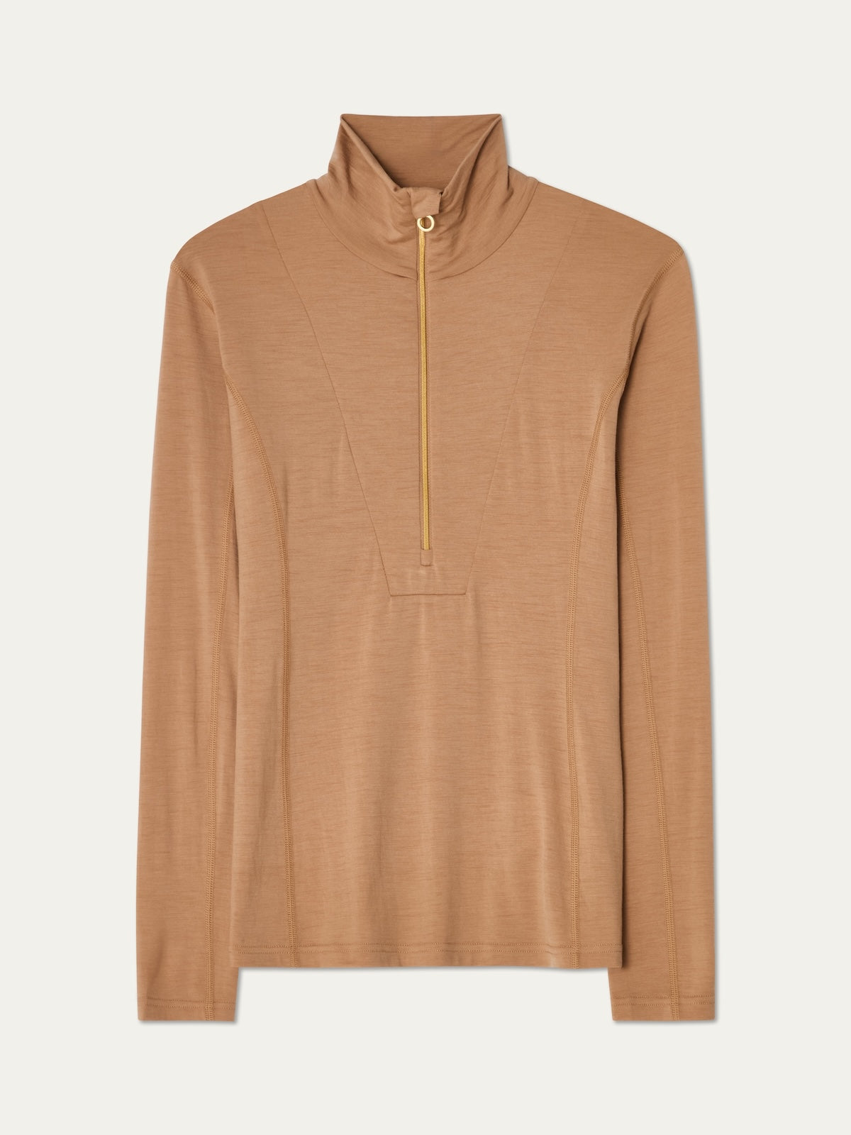 The Sno Merino Zip Up Women by We Norwegians is a light brown long-sleeve top featuring a high collar and front gold zipper. Crafted from breathable jersey fabric, its simple and minimal design includes subtle seam detailing on the front, offering a soft feel for effortless everyday comfort.