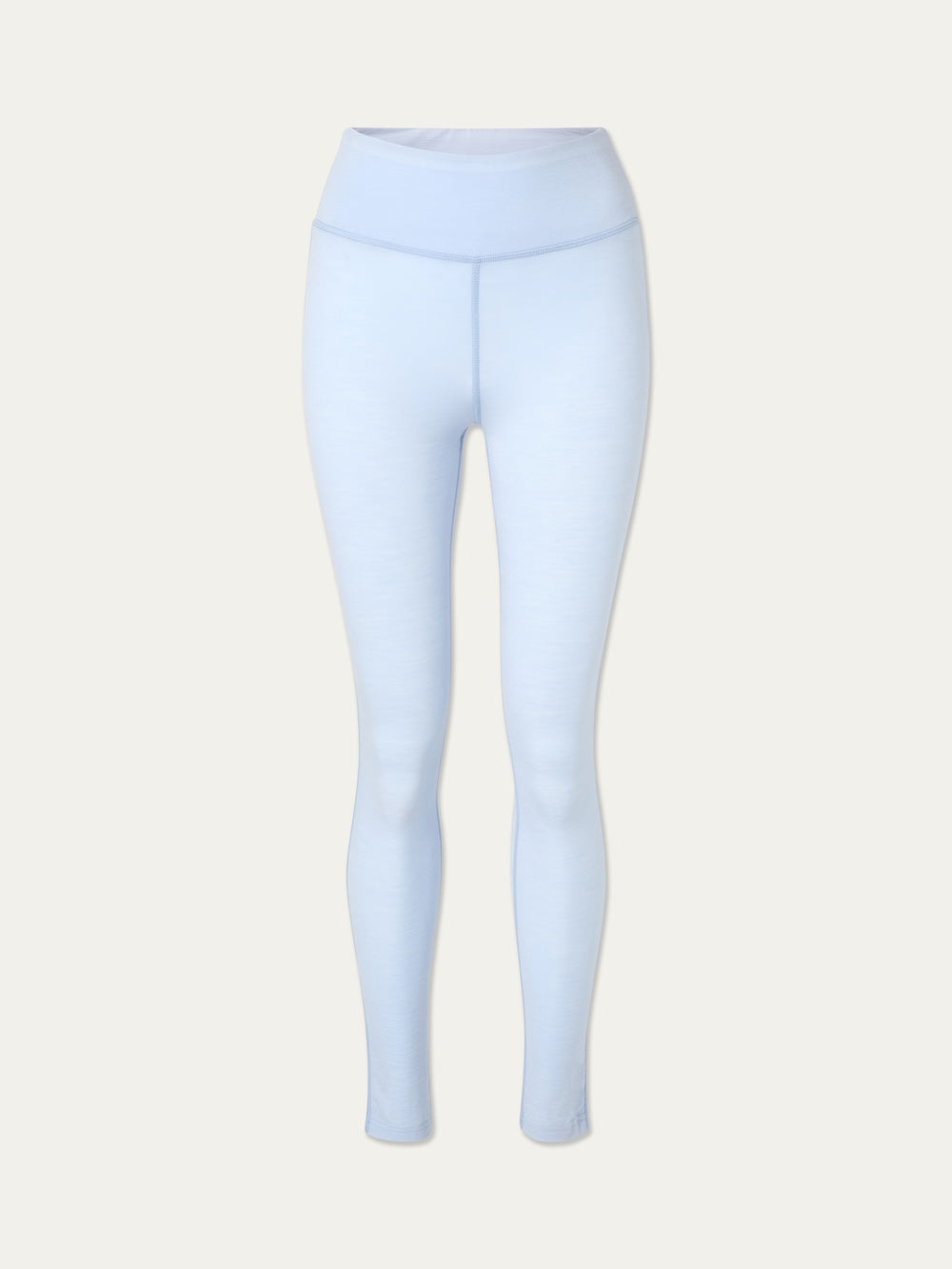 The We Norwegians Sno Merino Leggings Women are light blue, high-waisted leggings inspired by the comfort of Scandinavian base layers. Shown on a plain, light-colored background, these leggings offer a smooth, fitted look with full-length legs—ideal as breathable wool underwear for all-day comfort.