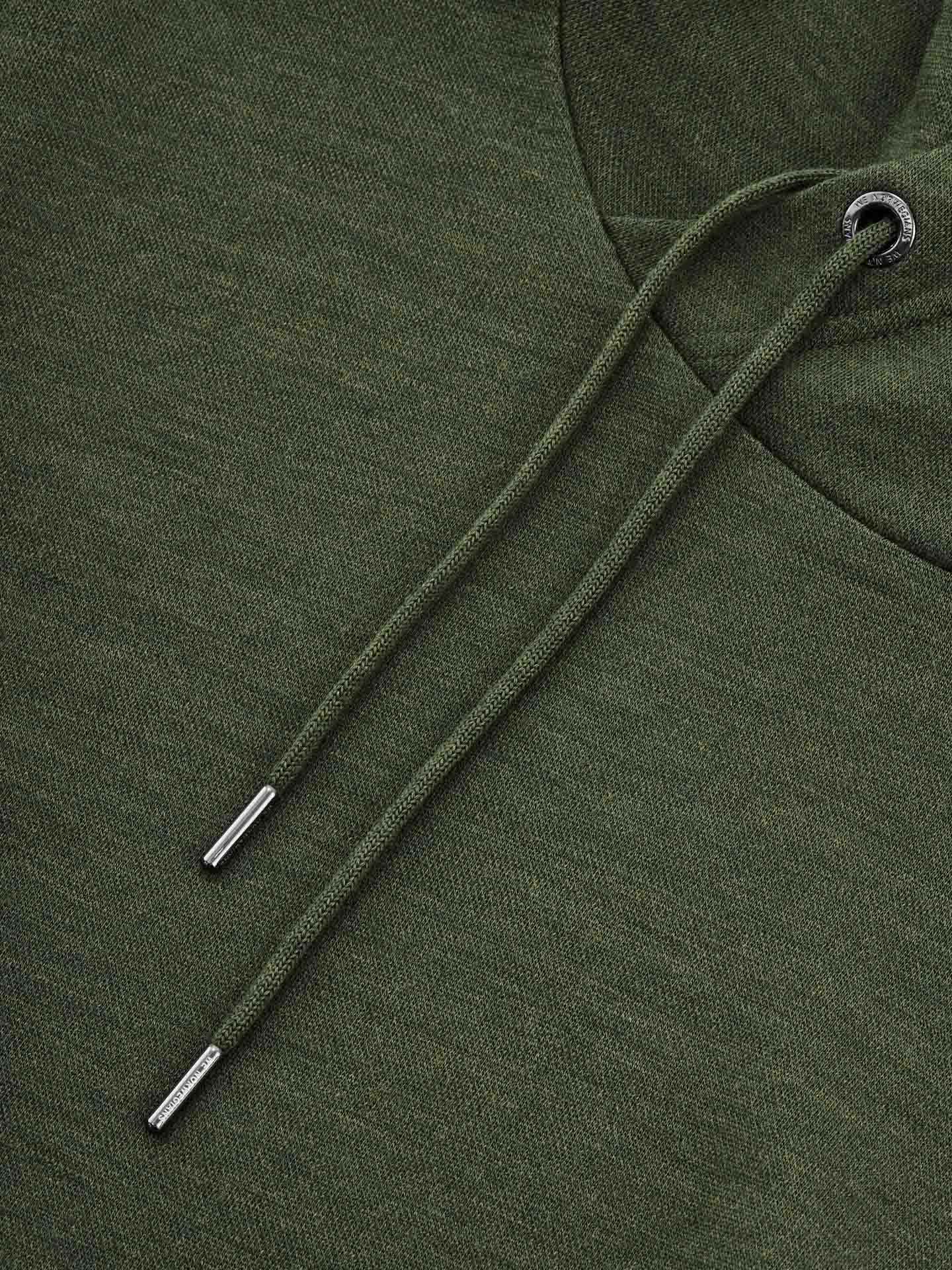 Close-up of a textured Olive Green Tind Hoodie crafted from superfine Merino wool by We Norwegians, featuring drawstrings with metal tips. One eyelet is visible at the top of the image, where the string emerges from this luxurious Italian yarn hoodie designed for men.