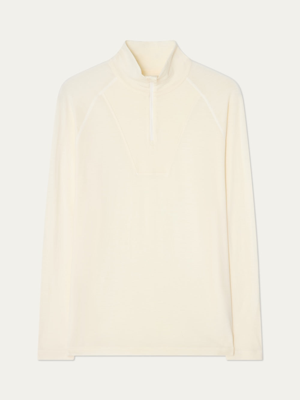 Sno Merino Zip Up Men by We Norwegians is an off-white, long-sleeve pullover featuring a high collar and quarter-zip front. Crafted from superfine merino wool, this minimalist piece provides breathable comfort and warmth—making it the perfect ski base layer. Shown against a plain background.