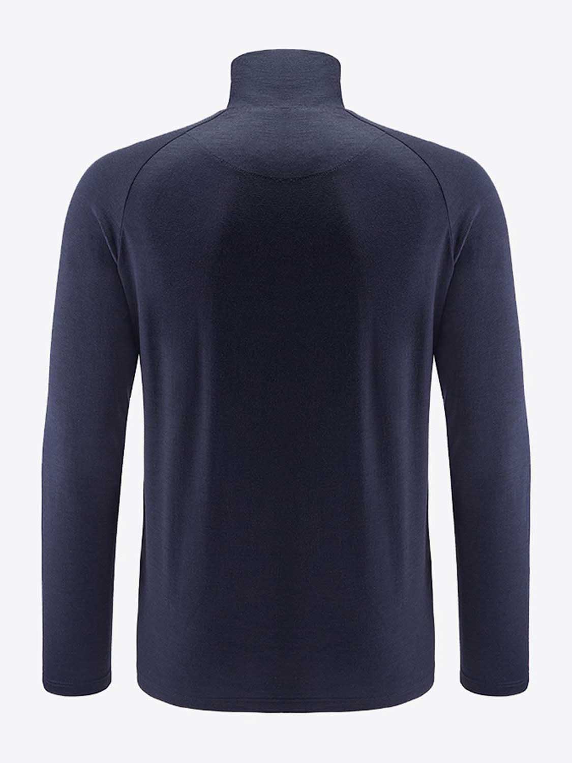 The Sno Merino Zip Up Men by We Norwegians is depicted from the back, showcasing its long sleeves and dark navy blue hue. Made from breathable merino wool, the fabric appears smooth and slightly fitted with no visible patterns or designs. The light grey backdrop contrasts beautifully with the shirt's dark color, epitomizing true Scandinavian luxury in base-layers.