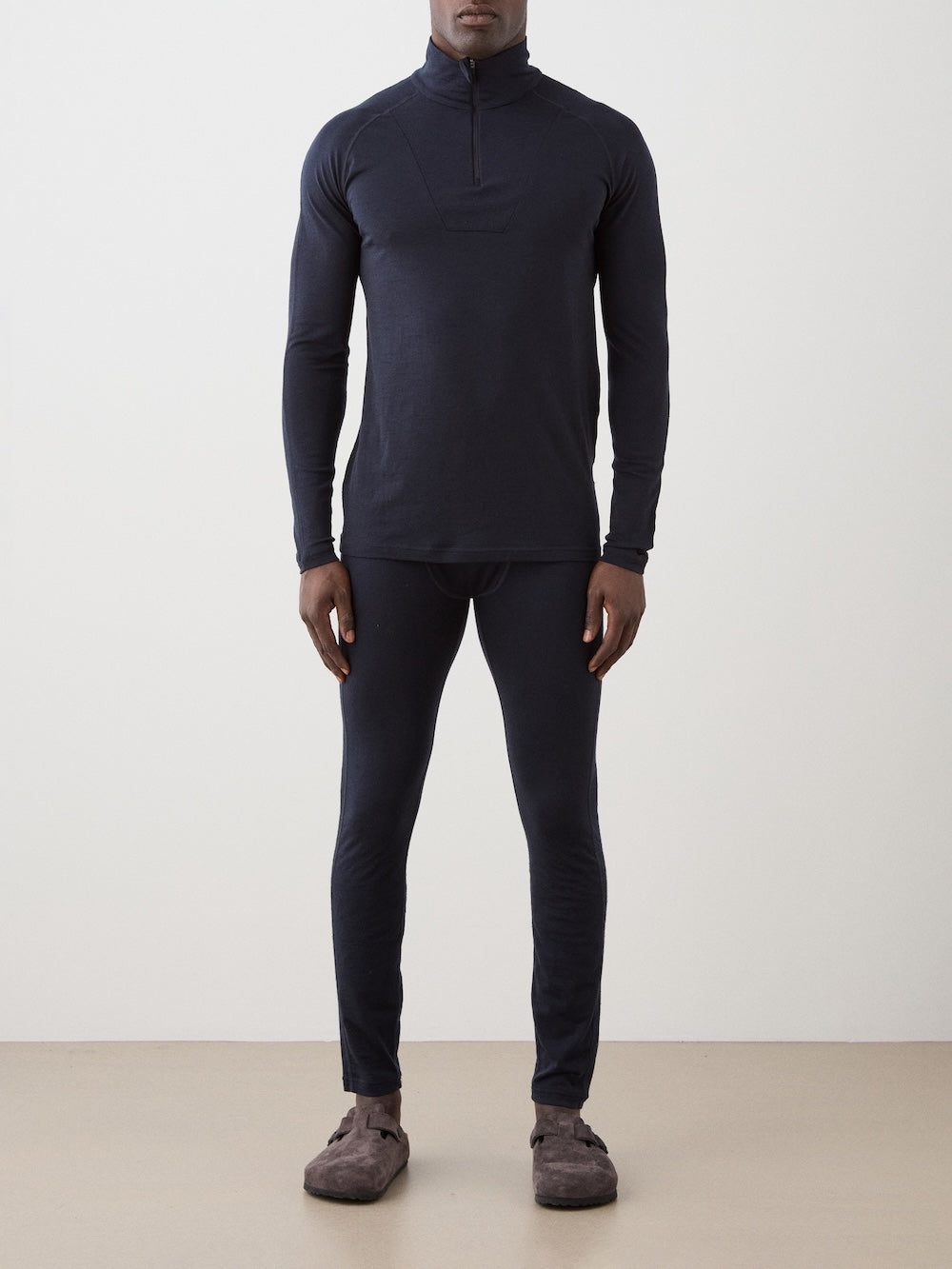 We Norwegians | FW25 | Mens Sno Zip-up_Navy blue | A close fit, breathable base layer with a stand collar, 1/4th zipper opening and long sleeves on an off-white background | Front