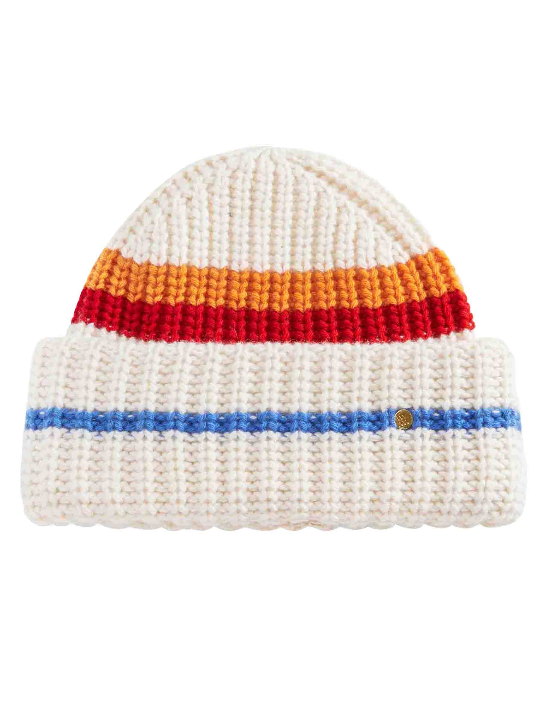 The Apres Ski Hat for Women by We Norwegians is a knitted white beanie featuring a folded brim with a blue horizontal stripe, evoking 70's ski fashion. The body of the beanie showcases alternating orange and red stripes at the top. Crafted from a luxurious merino cashmere blend, it boasts a ribbed texture and includes a small circular patch on the fold, making it perfect for an après ski hat.