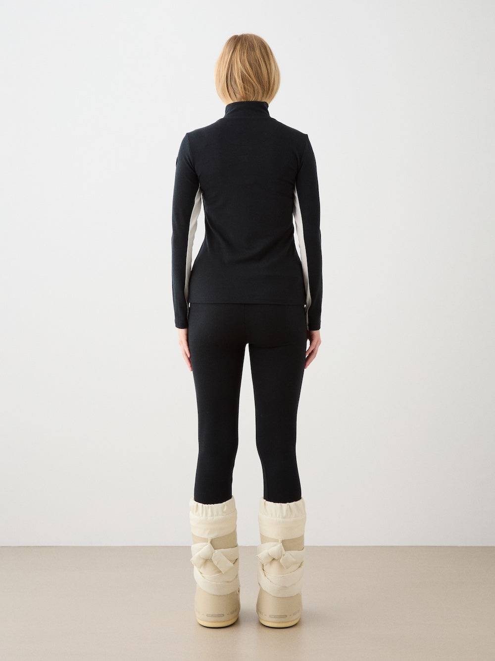 We Norwegians | FW25 | Womens Ski Basic legging_Black | Model is wearing these fine pair of knitted leggings that make a perfect base layer | Image shot against an off-white background | Back