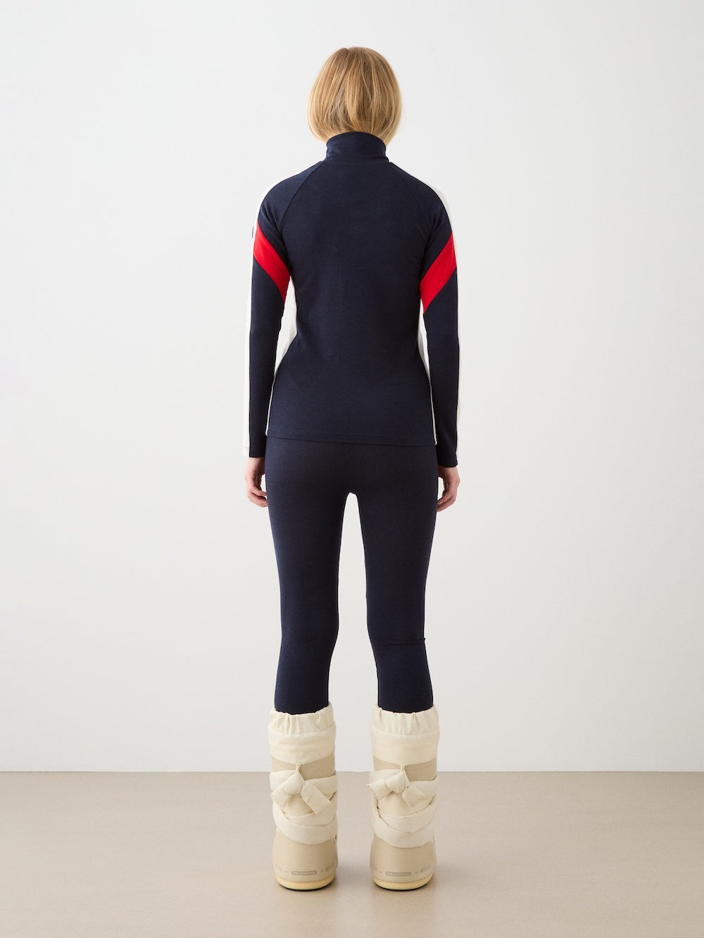 We Norwegians | FW25 | Womens Ski Basic legging_Navy blue | Model is wearing these fine pair of knitted leggings that make a perfect base layer | Image shot against an off-white background | Back