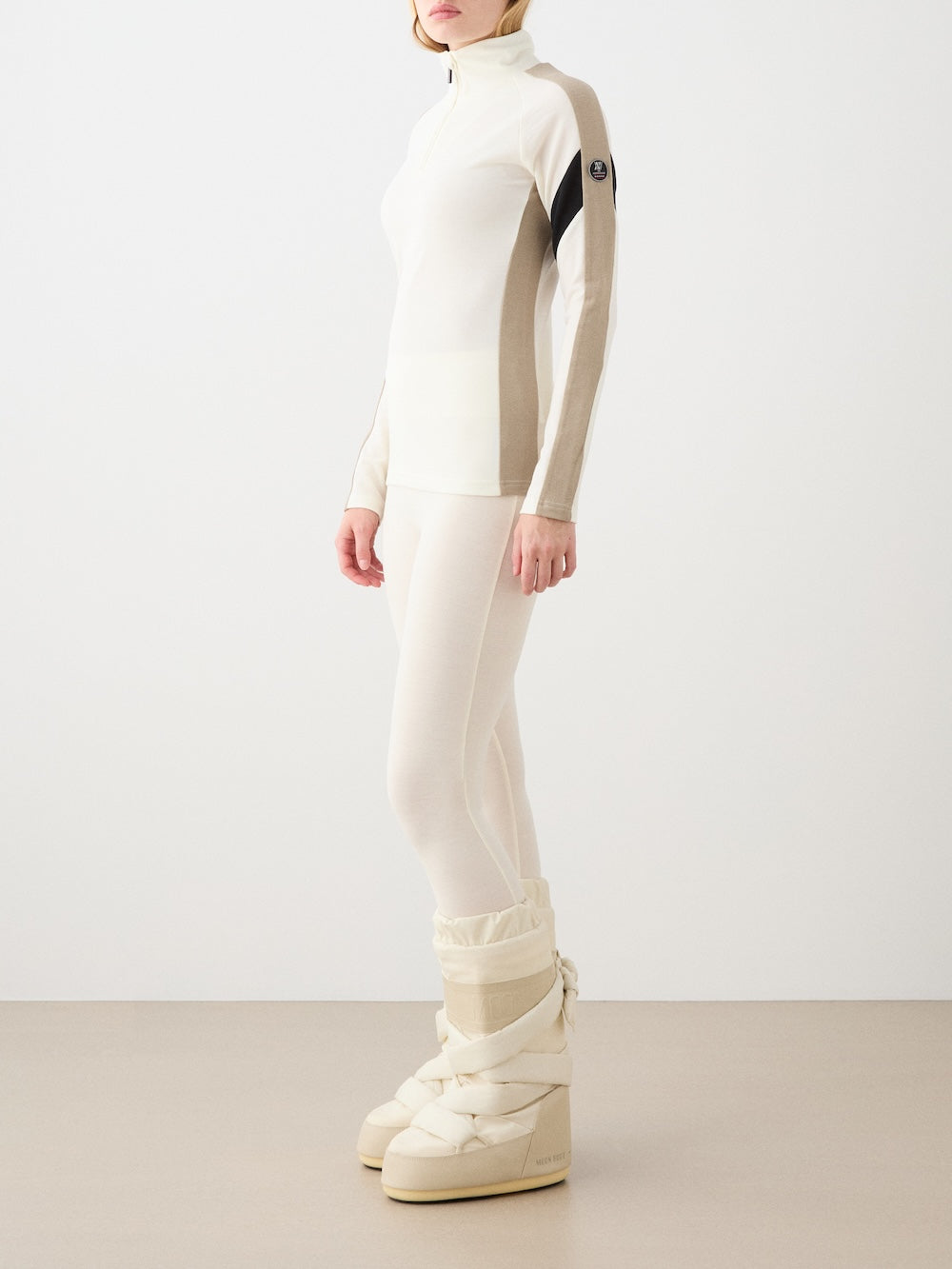 We Norwegians | FW25 | Womens Ski Basic legging_Off white | Model is wearing these fine pair of knitted leggings that make a perfect base layer | Image shot against an off-white background | Side