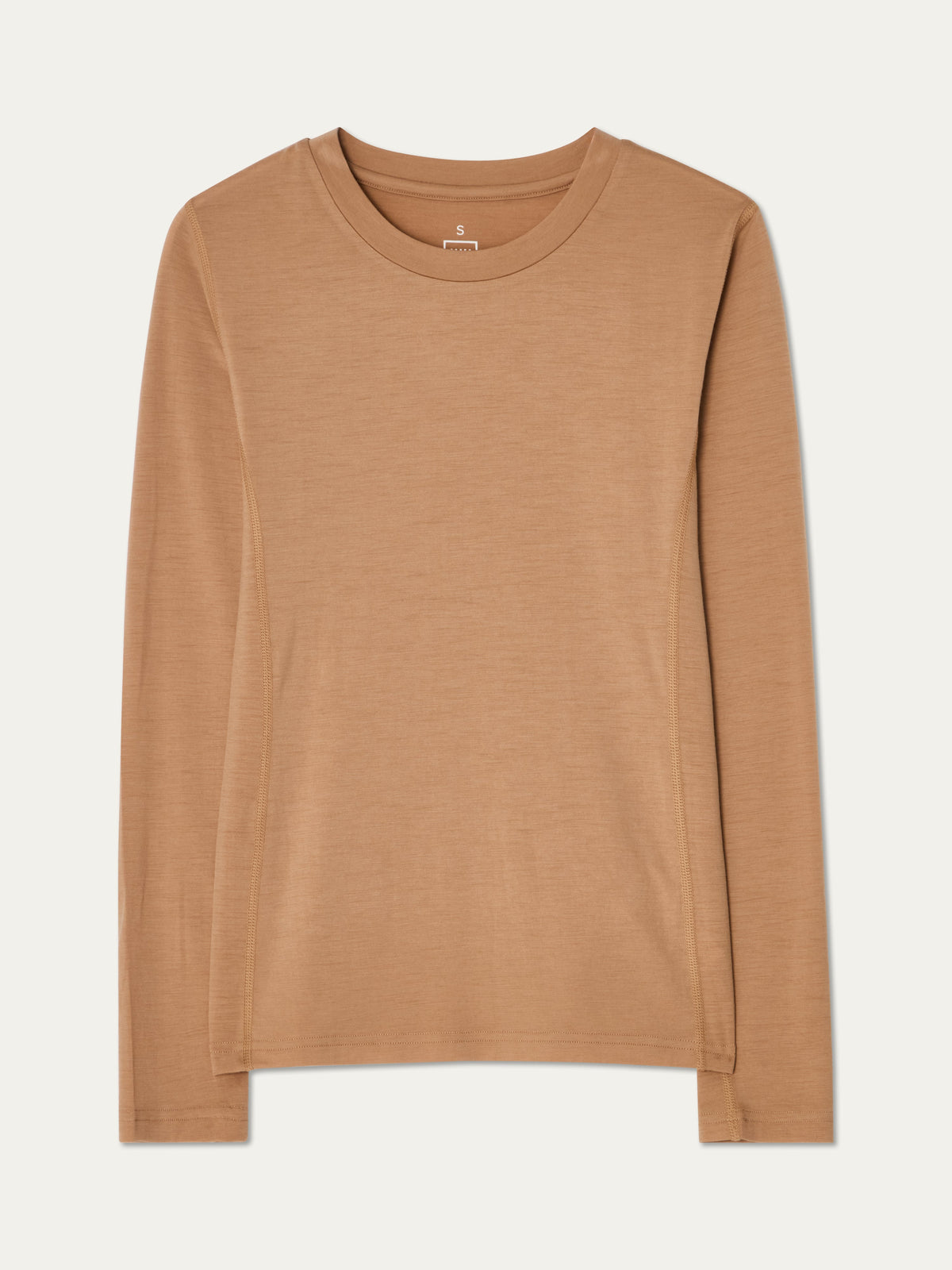 The Sno Merino Crewneck Women by We Norwegians is displayed flat on a cream background. This plain, long-sleeve T-shirt in light brown features a classic crew neckline and is crafted from soft, breathable single jersey merino wool for all-day comfort.