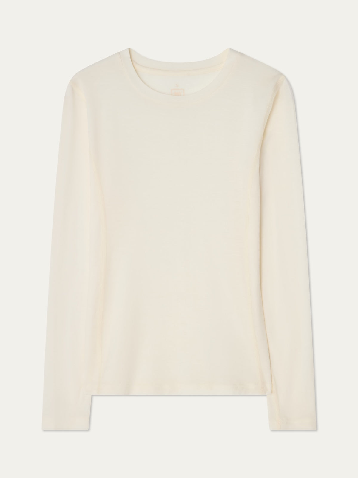 The We Norwegians Sno Merino Crewneck Women is a plain, long-sleeve, off-white top made from breathable jersey fabric, shown laid flat on a white background.