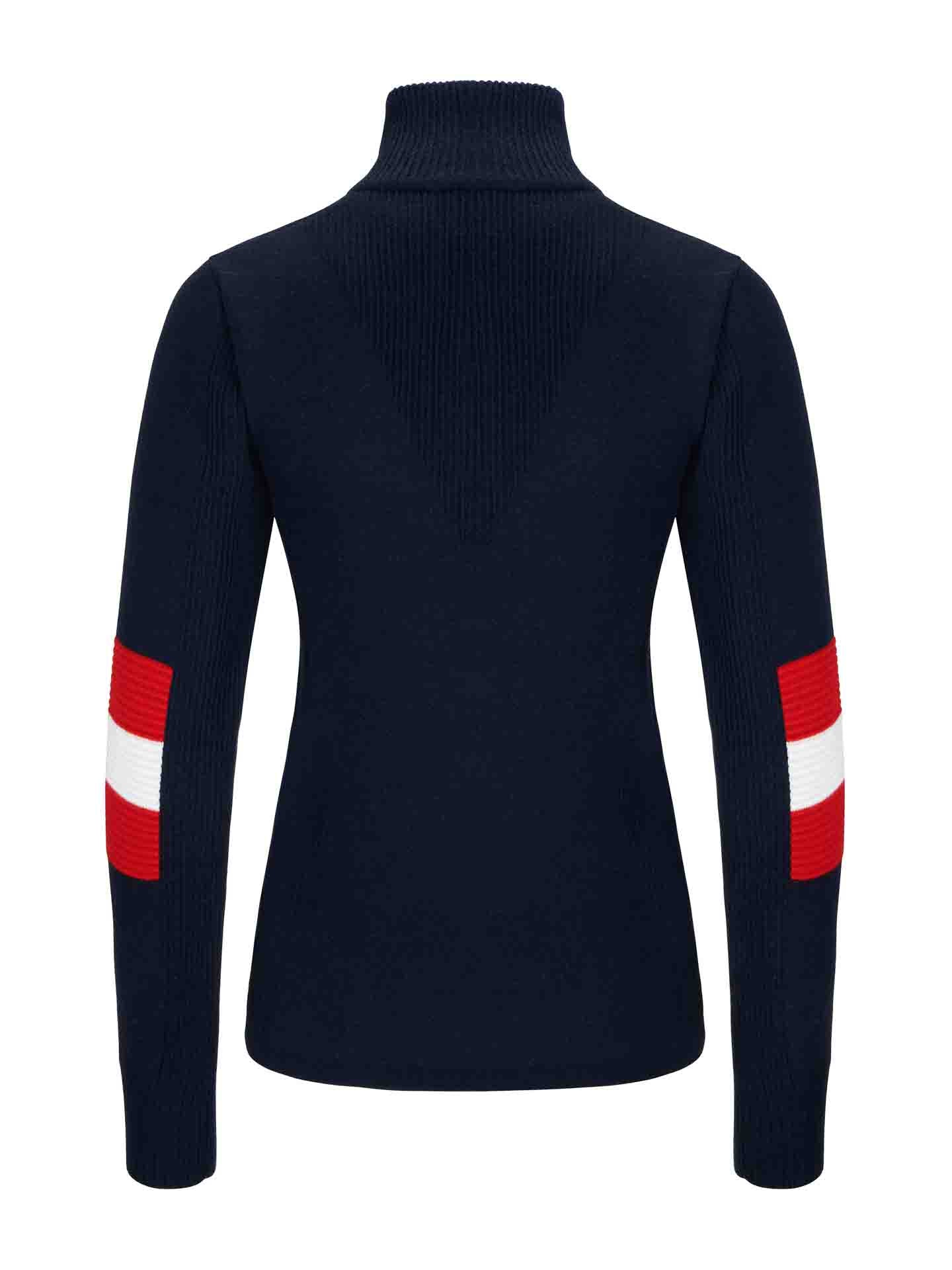 The Hafjell Zip Up Women by We Norwegians is a navy blue turtleneck sweater with long sleeves that feature broad horizontal stripes in red and white on the elbows. This fitted design, expertly crafted by Italian knitters, is made of ribbed knit material reminiscent of fine merino wool ski sweaters.