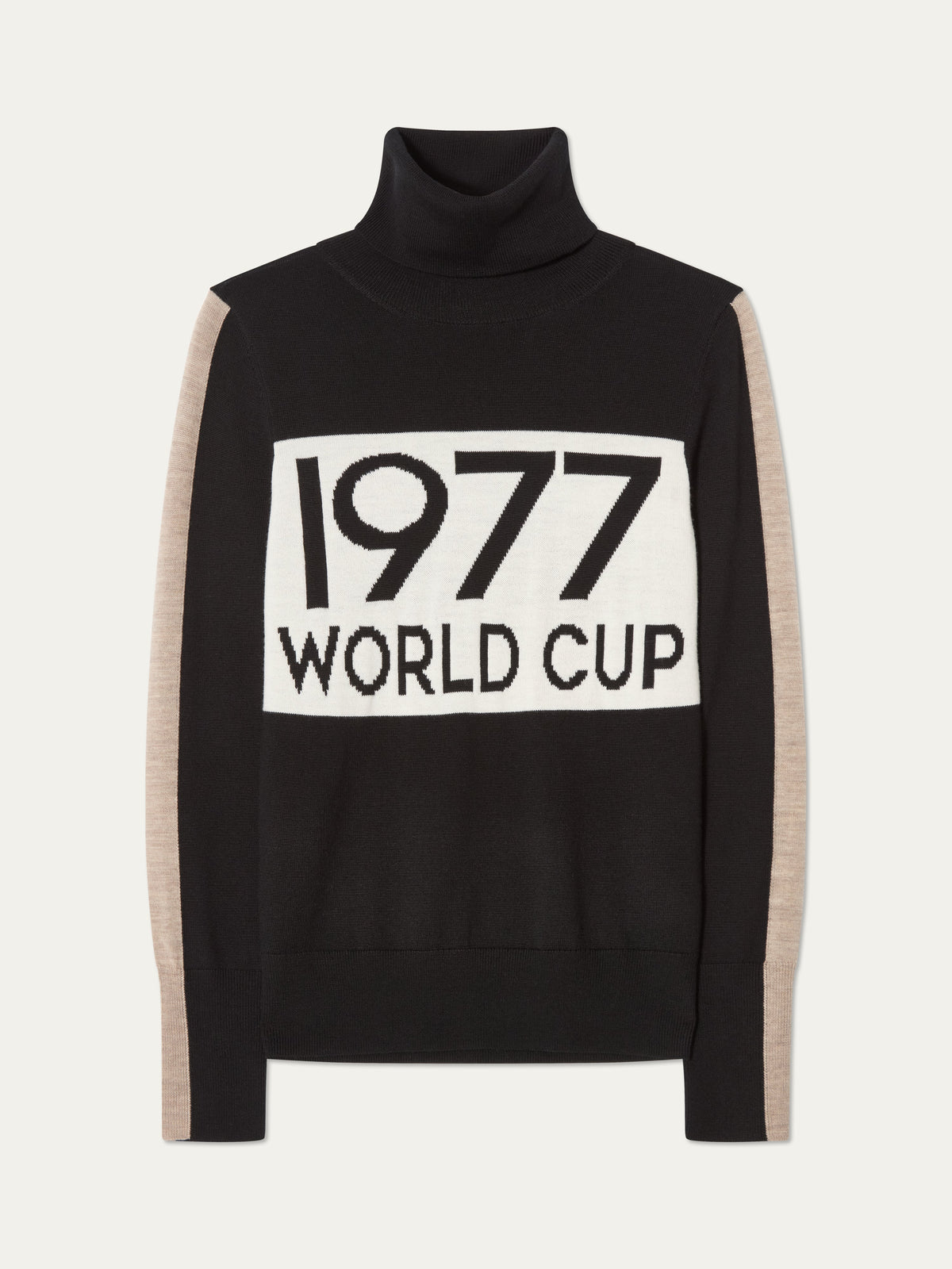 The 1977 World Cup Sweater Women by We Norwegians features a black turtleneck, beige sleeves, and a white front panel emblazoned with “1977 WORLD CUP” in bold black letters, channeling vintage-inspired retro ski style.
