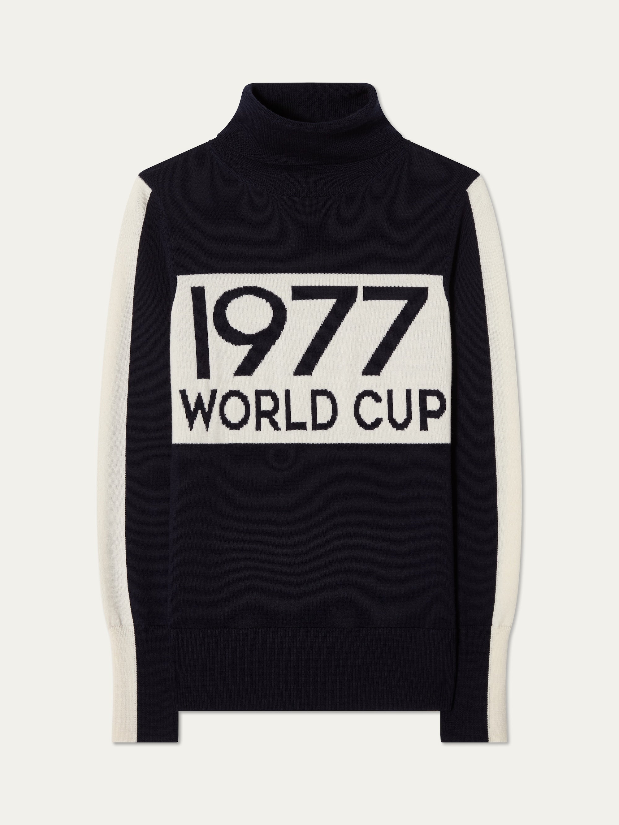 The We Norwegians 1977 World Cup Sweater Women is a black merino wool ski sweater with white sleeves and "1977 WORLD CUP" boldly on the front, inspired by iconic 70s skiing style.