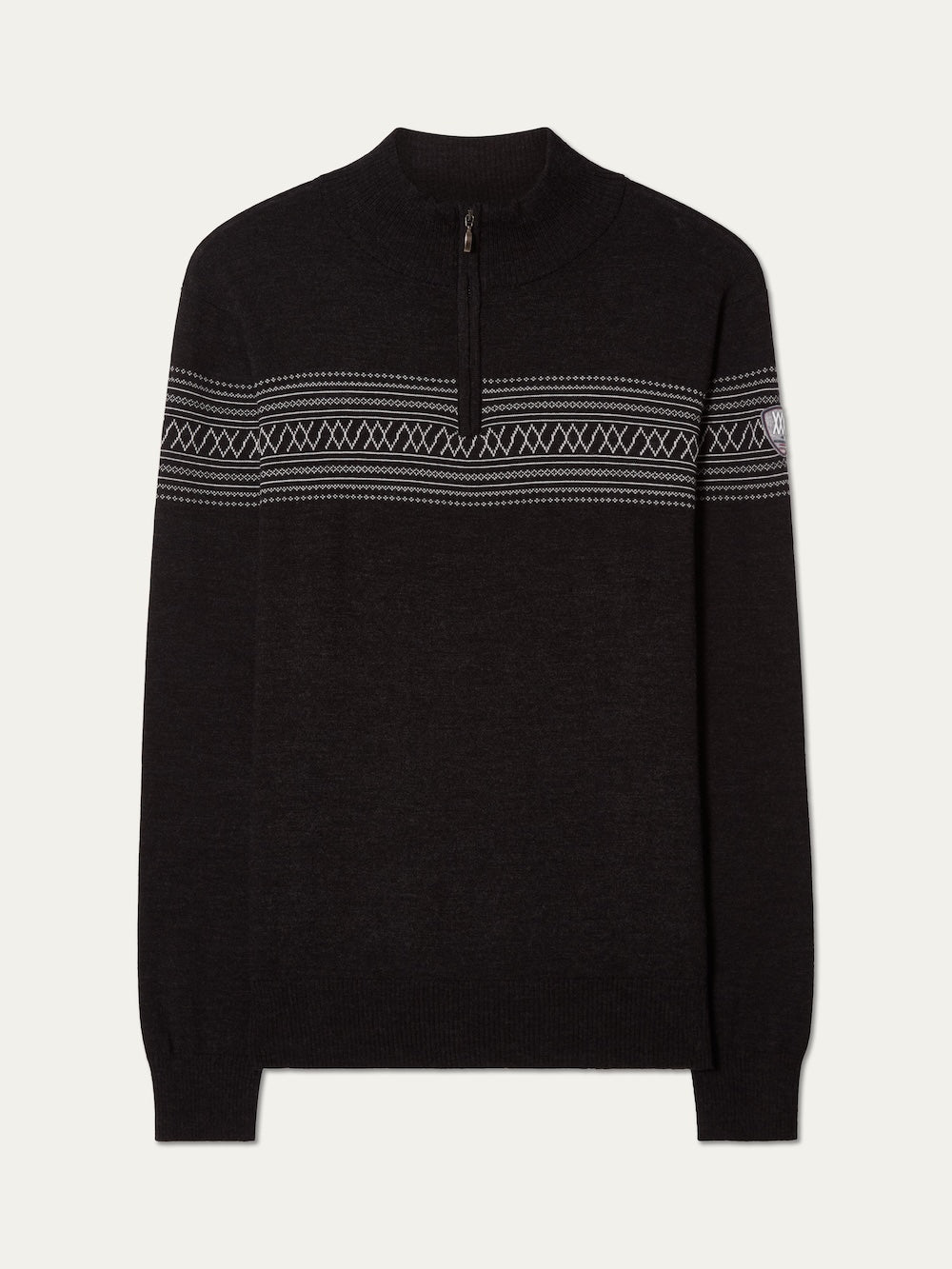 The We Norwegians Signature Zip Up Men is a black quarter-zip sweater featuring a white Norwegian Setesdal pattern across the chest and upper arms, ribbed cuffs and hem, and a small logo patch on the left sleeve. Made from washable merino wool, this zip-up is displayed laid flat on a light background.