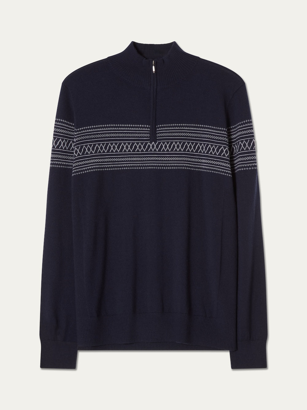 The We Norwegians Signature Zip Up Men is a navy blue pullover sweater featuring a half-zip collar and white Norwegian Setesdal pattern across the chest and arms, crafted from washable merino wool for comfort and easy care.