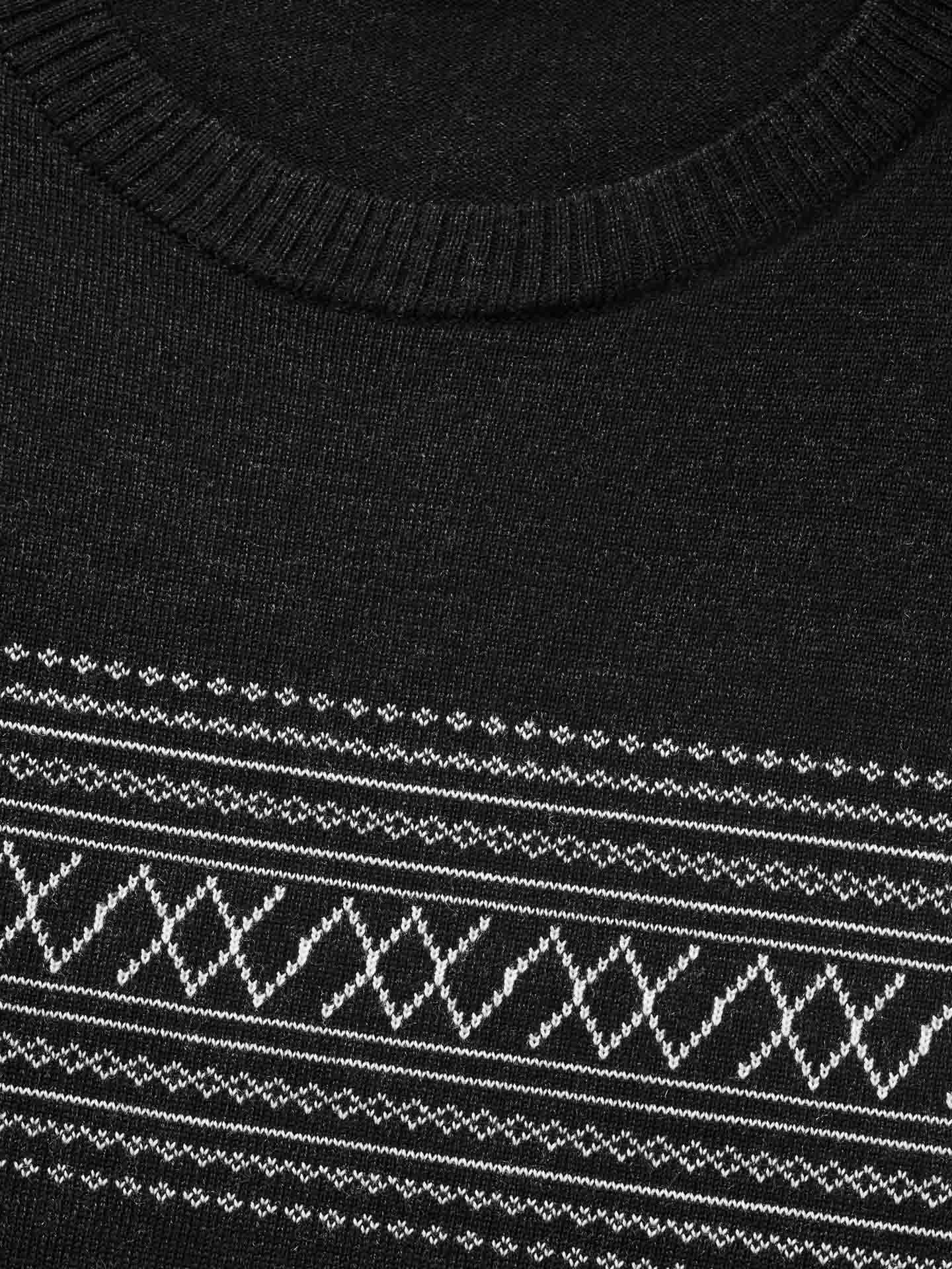 A close-up of the We Norwegians Signature Crewneck Men base layer in black, featuring a white geometric pattern across the chest. The design includes lines forming diamond shapes and small X shapes above and below. This sweater, steeped in Norwegian heritage, is completed with a ribbed collar.