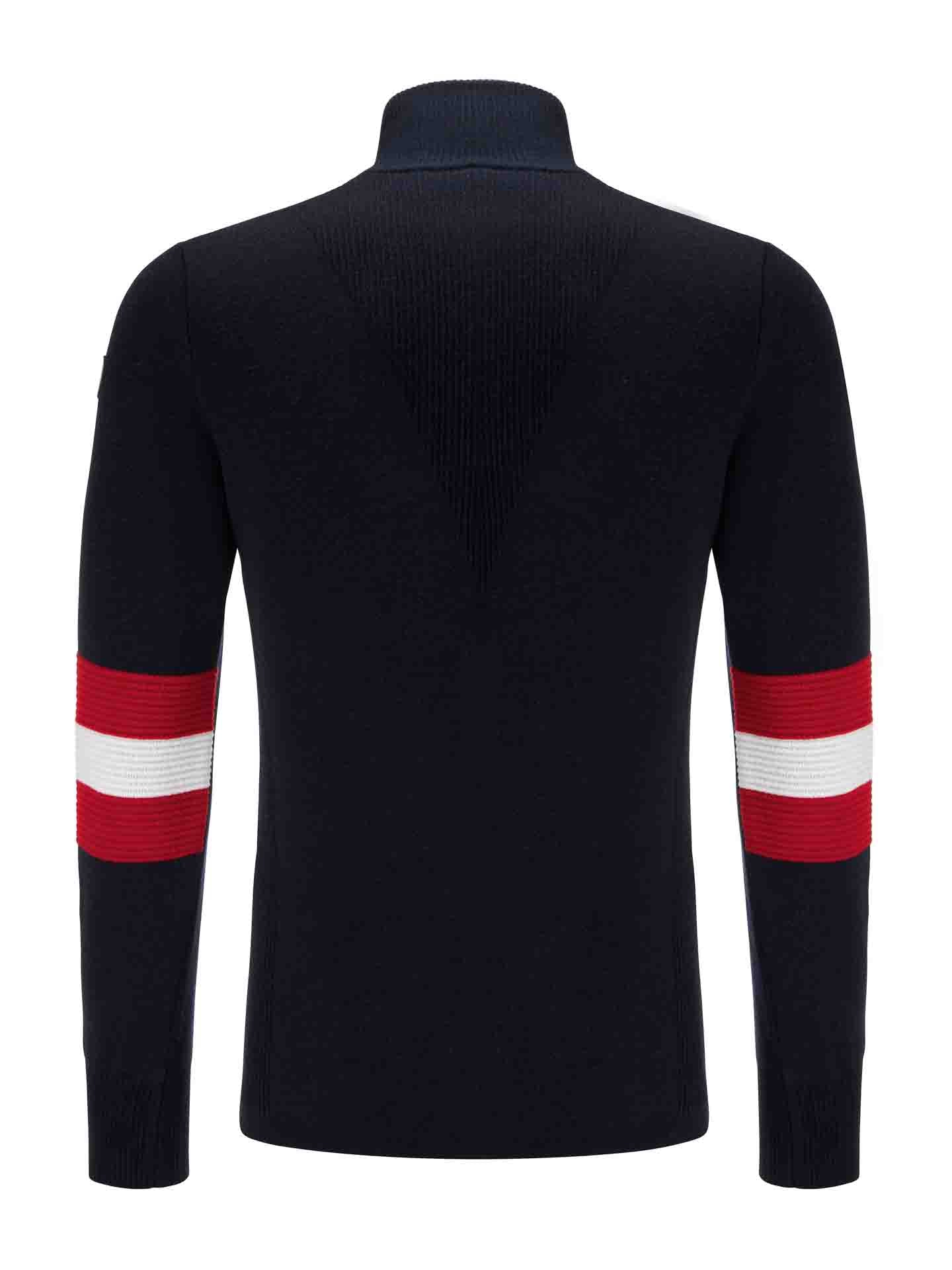 Back view of the We Norwegians Hafjell Zip Up Men sweater, featuring black fabric with red and white horizontal stripes on the sleeves. Made by Italian knitters, this sweater boasts a ribbed texture on the shoulders, upper back, and collar. Crafted from 100% fine merino wool, it offers a stylish nod to classic ski sweaters.