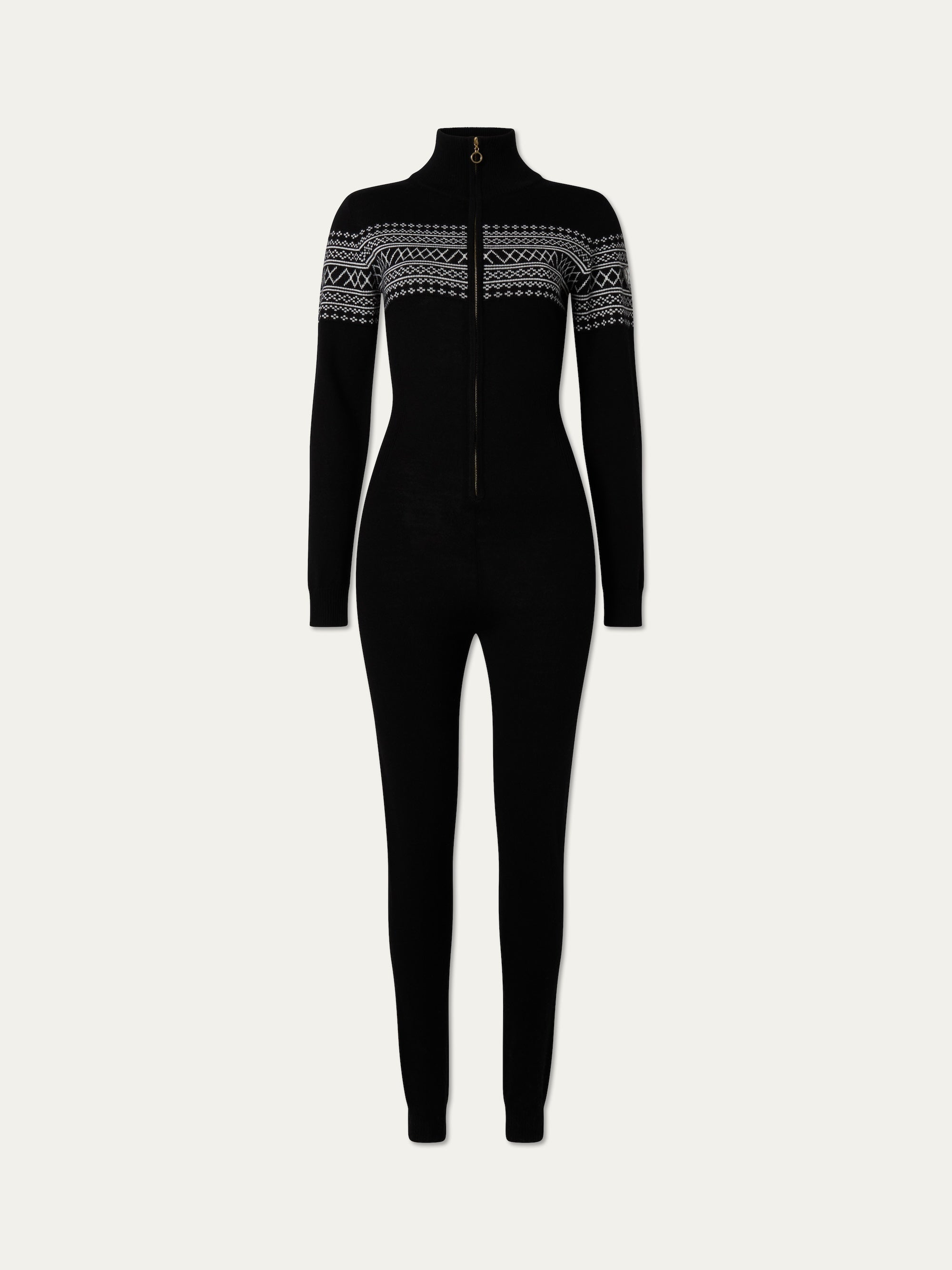 The We Norwegians Signature Jumpsuit Women is a black, long-sleeve full-body jumpsuit featuring a high collar, front zipper, and white geometric chest patterns—ideal for après-ski or as a stylish merino wool base layer.
